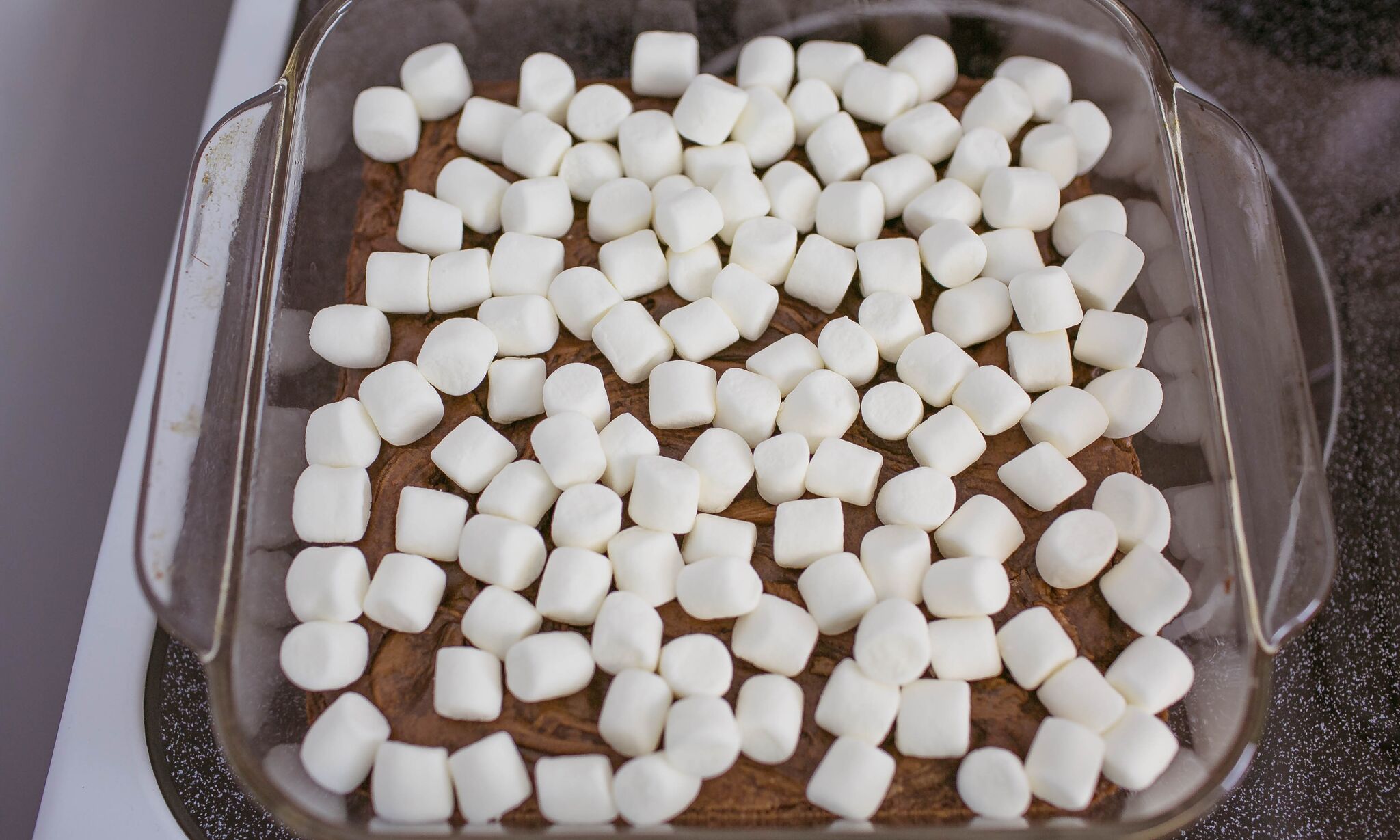 Bake brownies according to package instructions and top with mini marshmallows. 