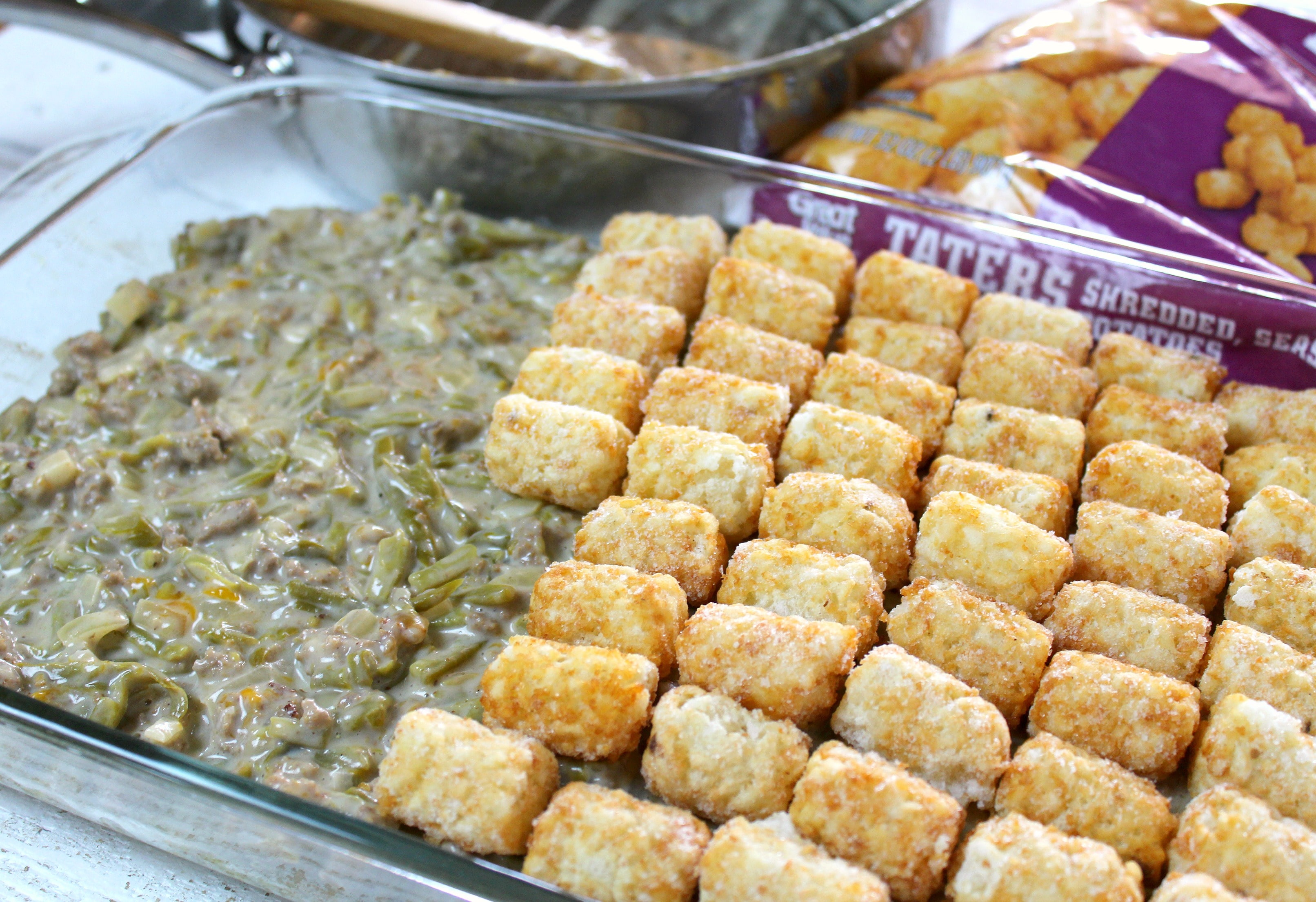 Tater Tot Casserole | Pour mixture into the 9x13 pan and top with a layer of frozen tater tots.