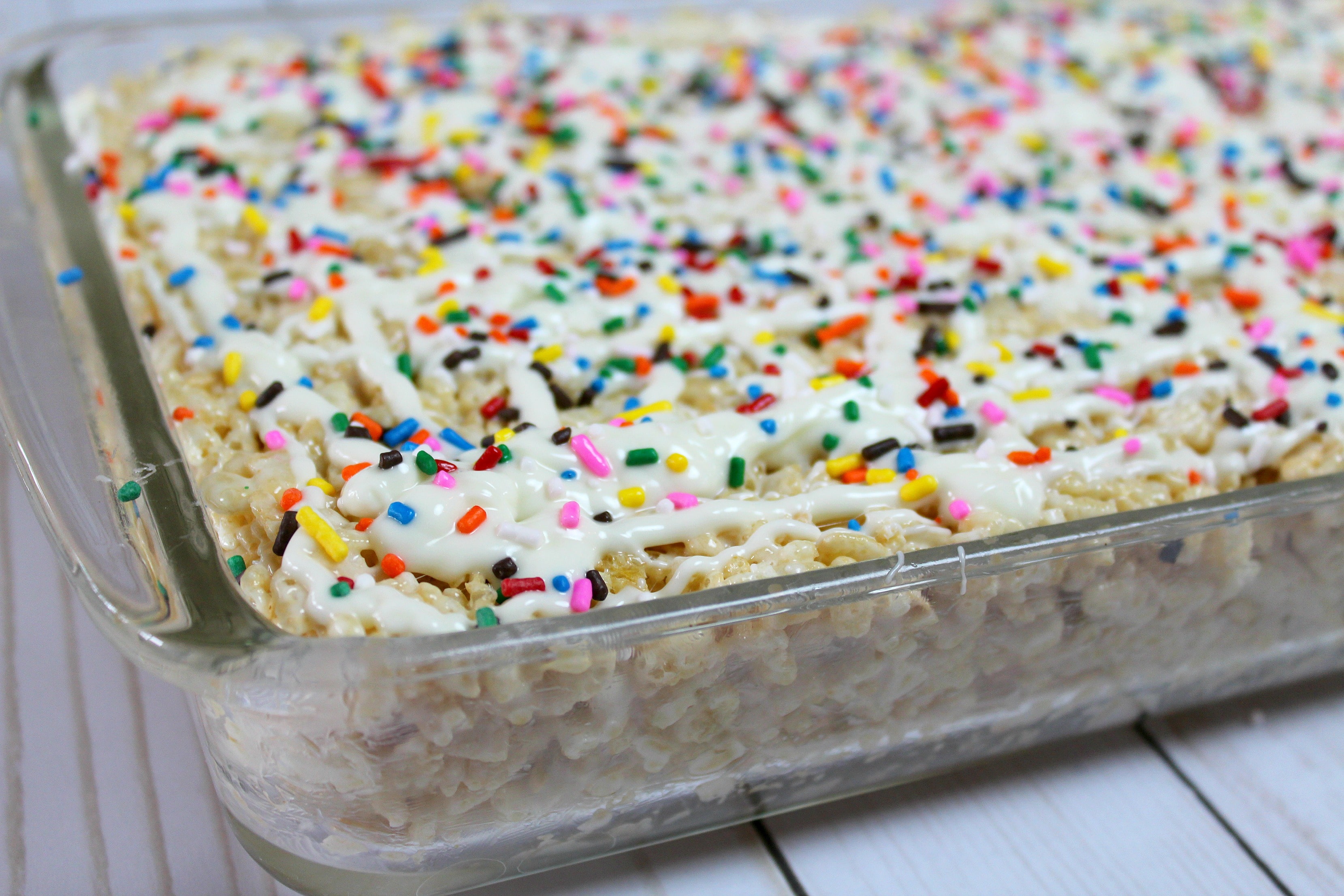 Drizzle the icing over the top of the rice crispy treats and add sprinkles. 