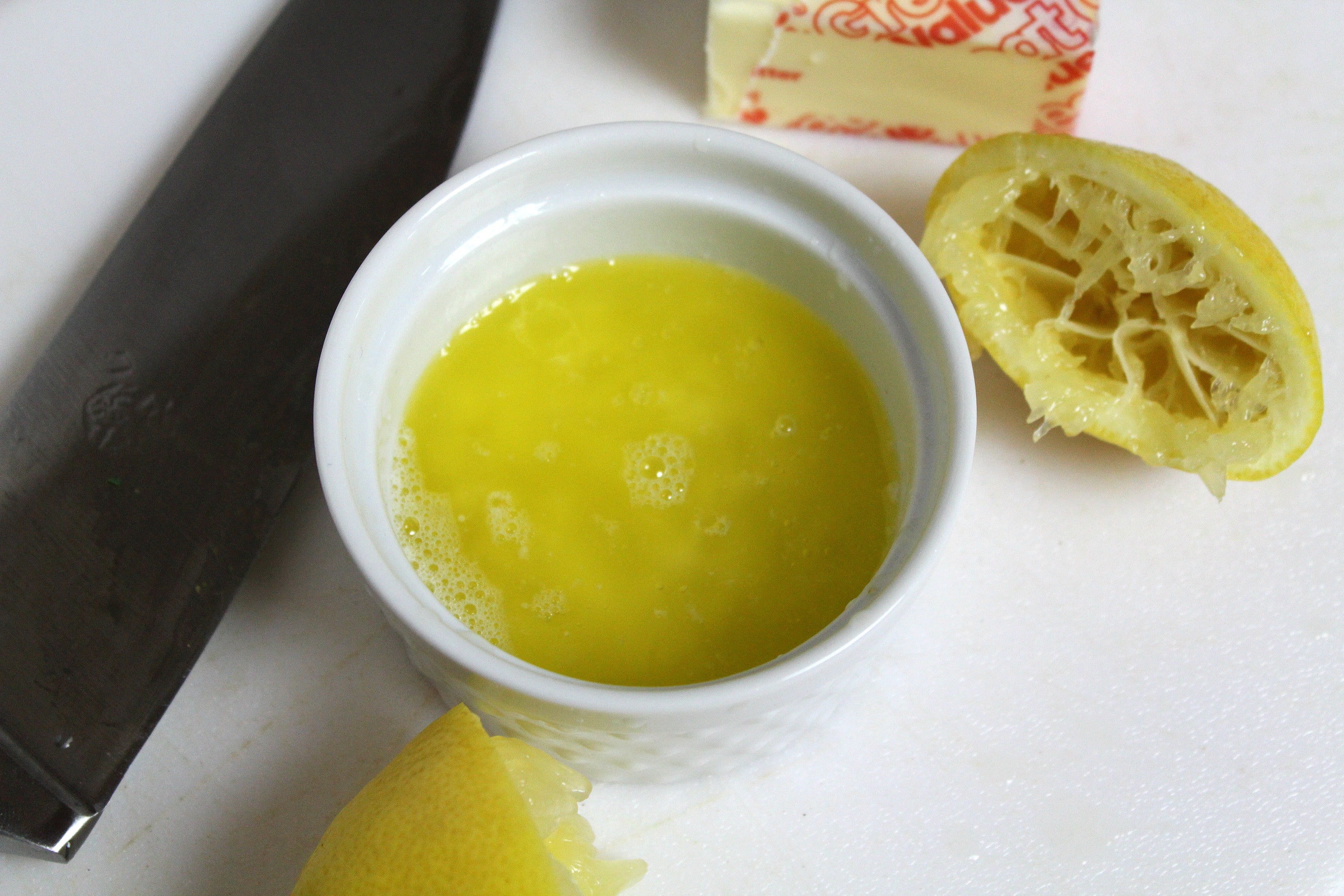 Combine juice of one lemon, butter, salt, and pepper together. 