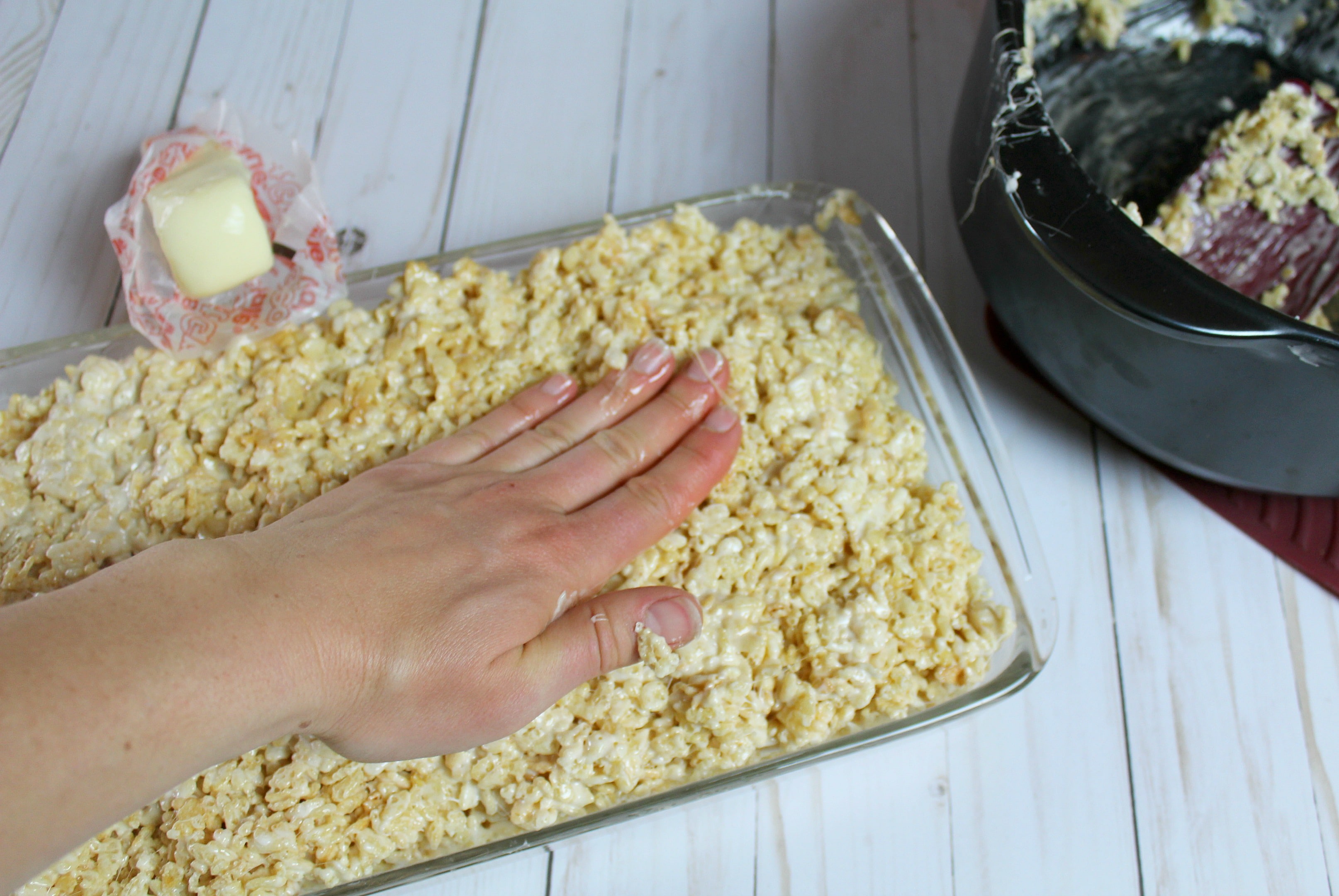 Press the rice crispy mixture into the pan with your hand. 