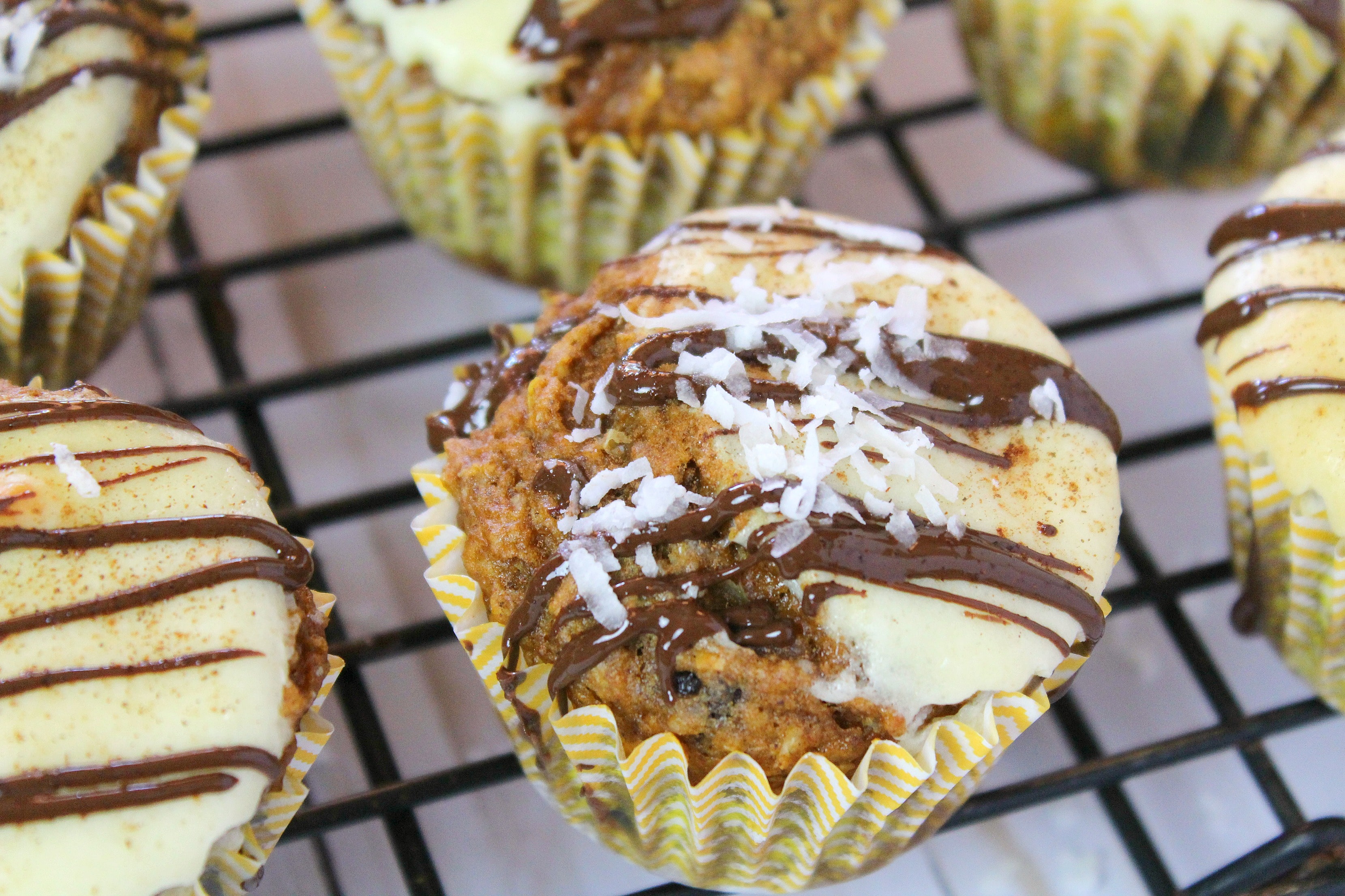 Add a drizzle of chocolate and shredded coconut to finished muffins then enjoy.