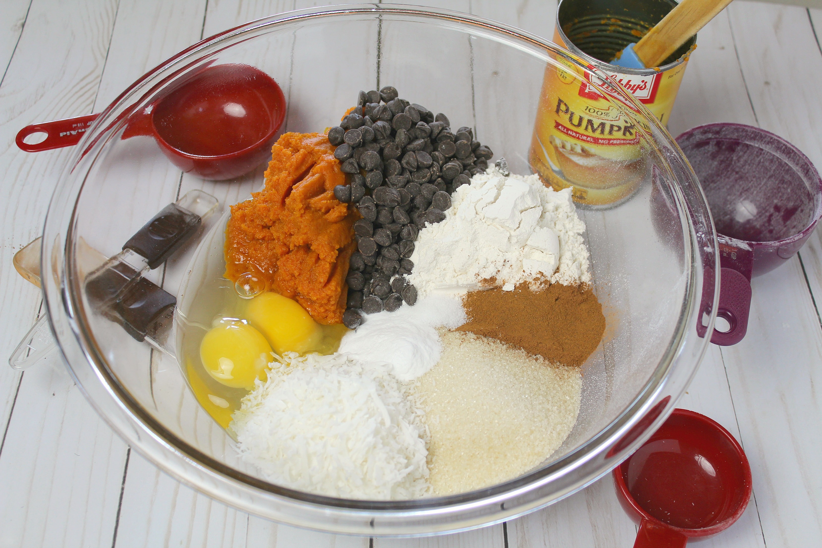 In large bowl, mix together flour, sugar, cinnamon, baking soda, salt, eggs, pumpkin, coconut and chocolate chips.  