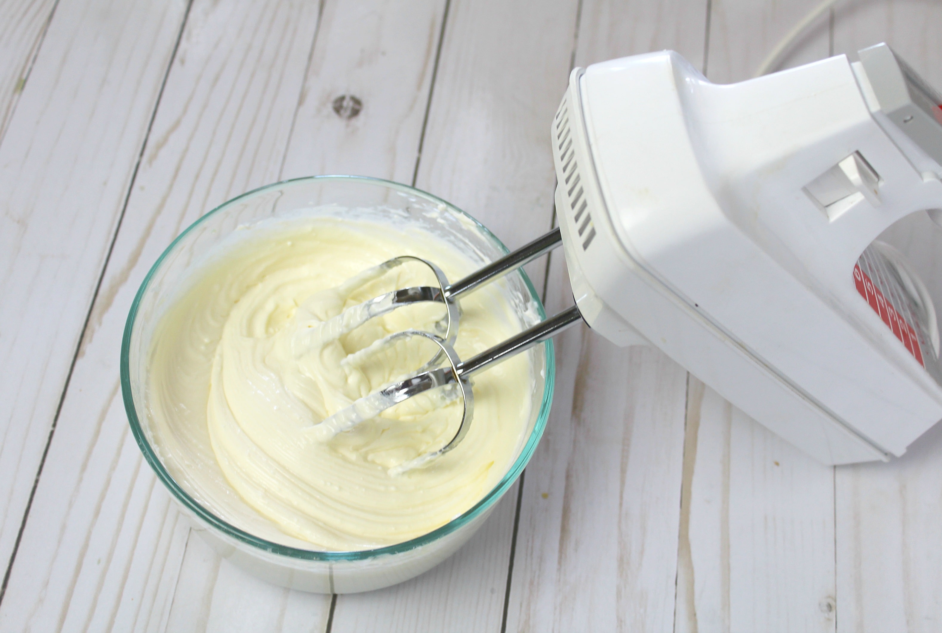 In a bowl beat cream cheese, sugar and an egg on high until fluffy and smooth.