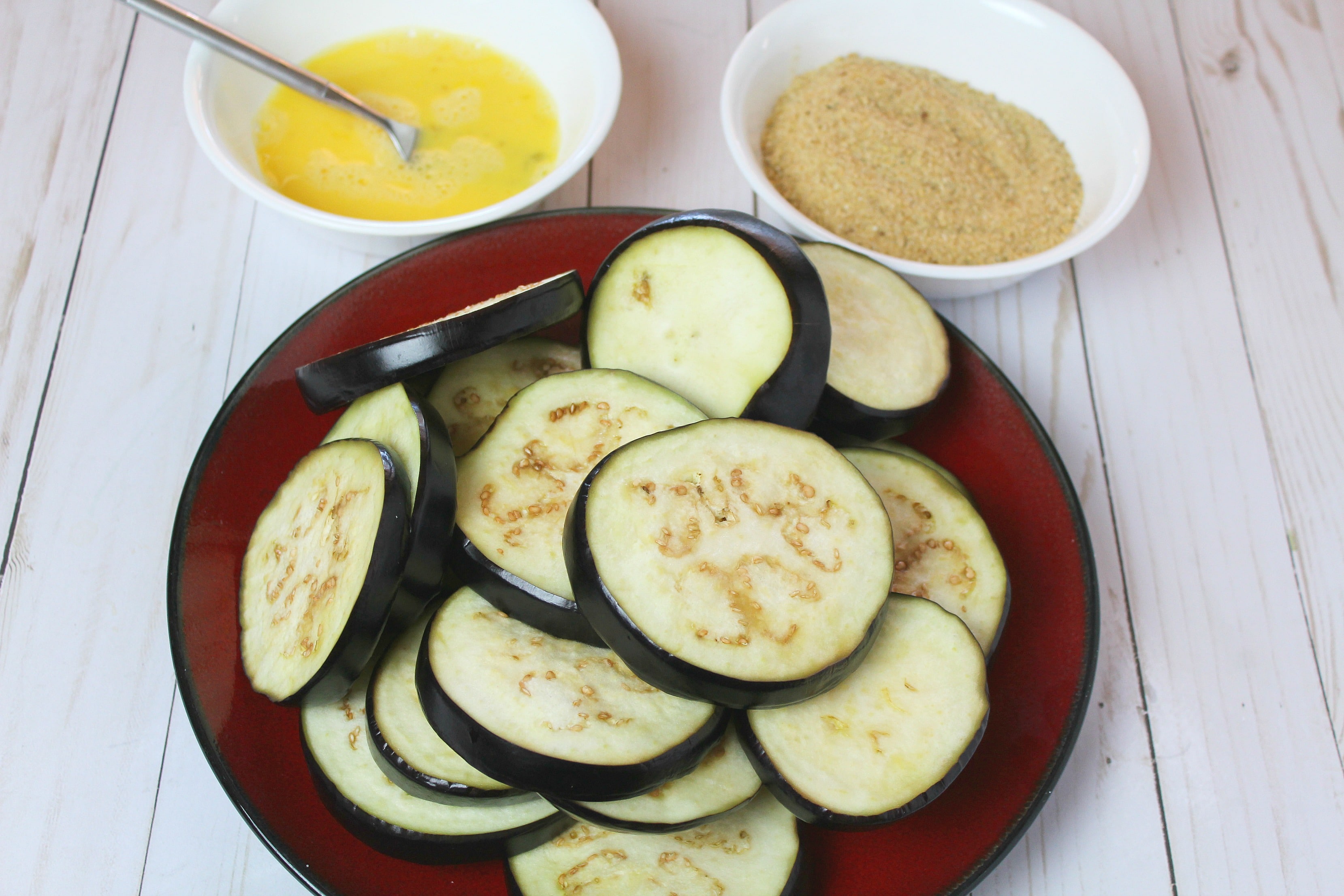 Whisk eggs well in small bowl and set aside with bread crumbs in a second bowl near eggplant pieces. 