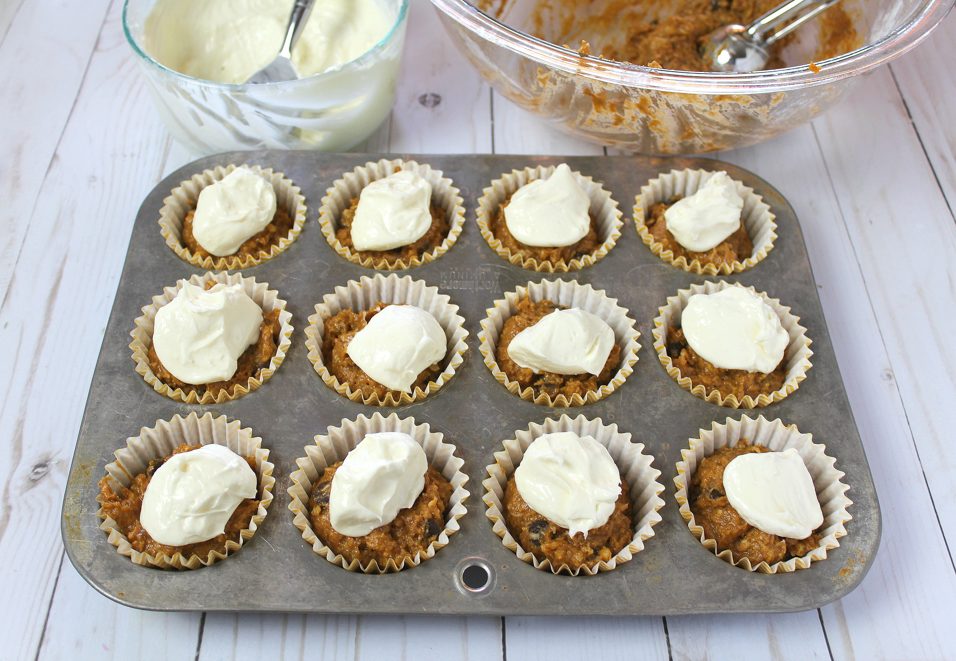 Fill muffin cups approximately 2/3 full with pumpkin batter and place a spoonful of cream cheese mixture in the center. 