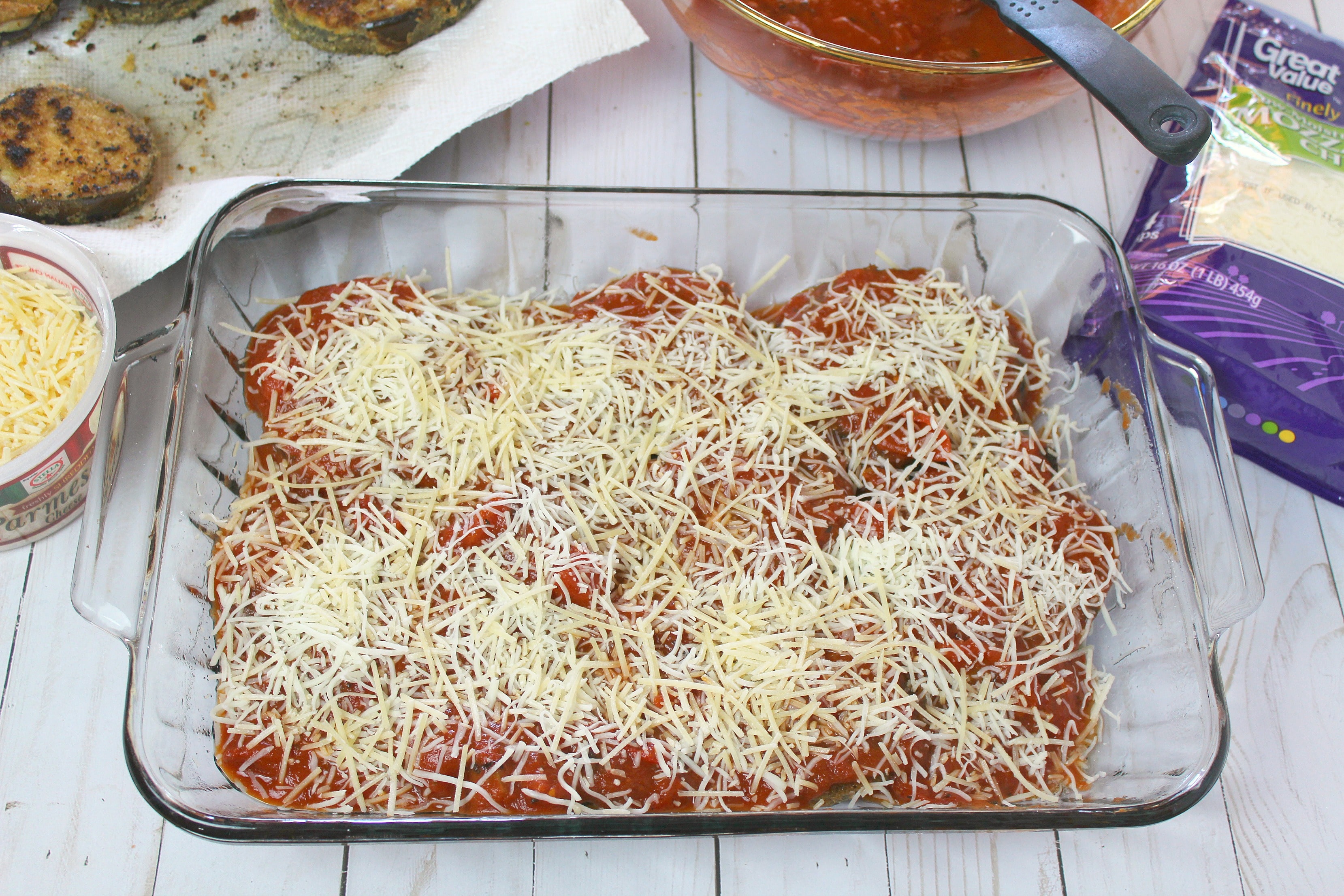 Layer eggplant over with sauce and cheeses in baking dish. 