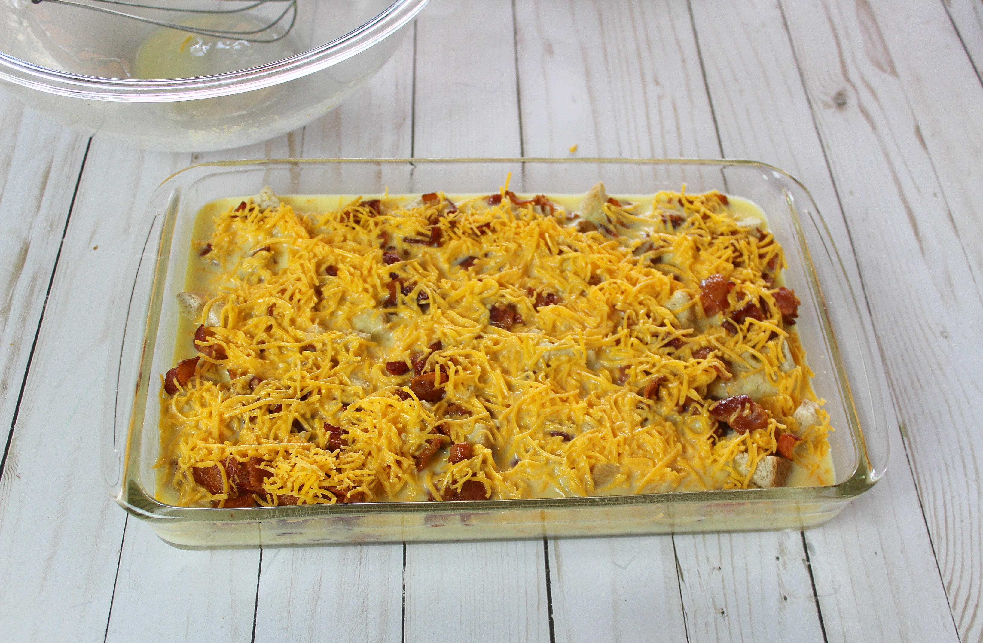 Pour egg mixture into casserole dish over bread, meat and cheese.