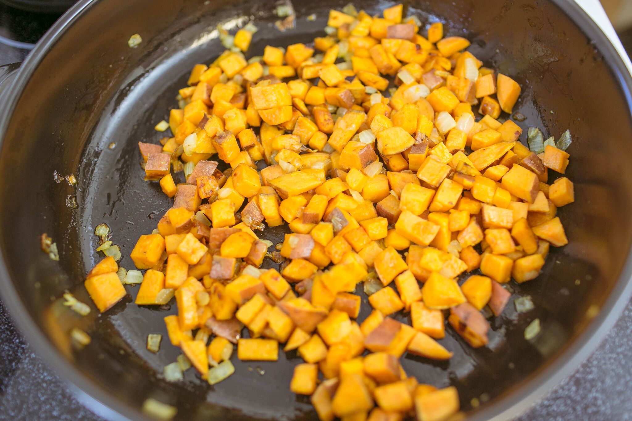 Melt butter in frying pan and saute sweet potato and onion. 