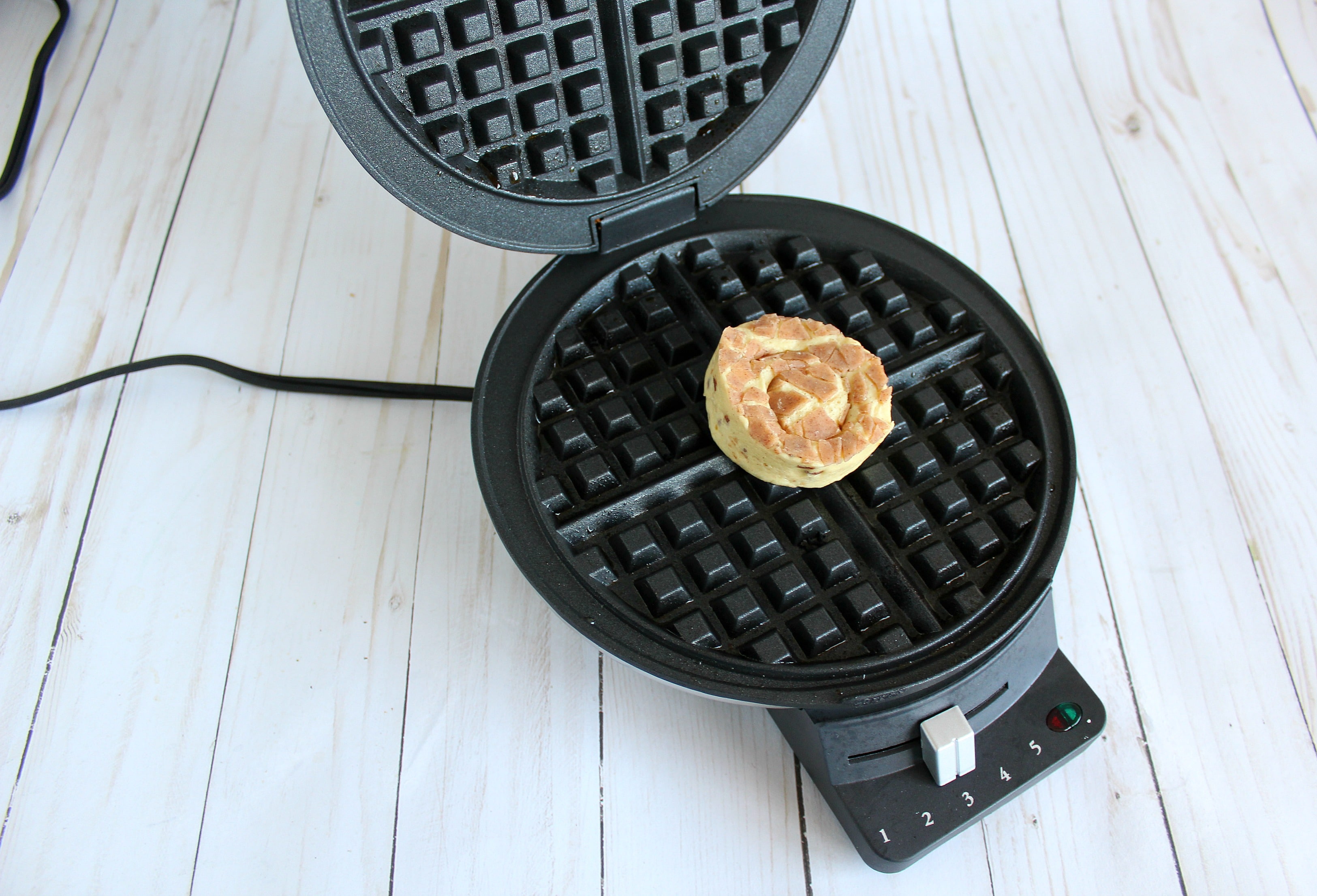 Cook one cinnamon roll in the waffle maker for about 5 minutes