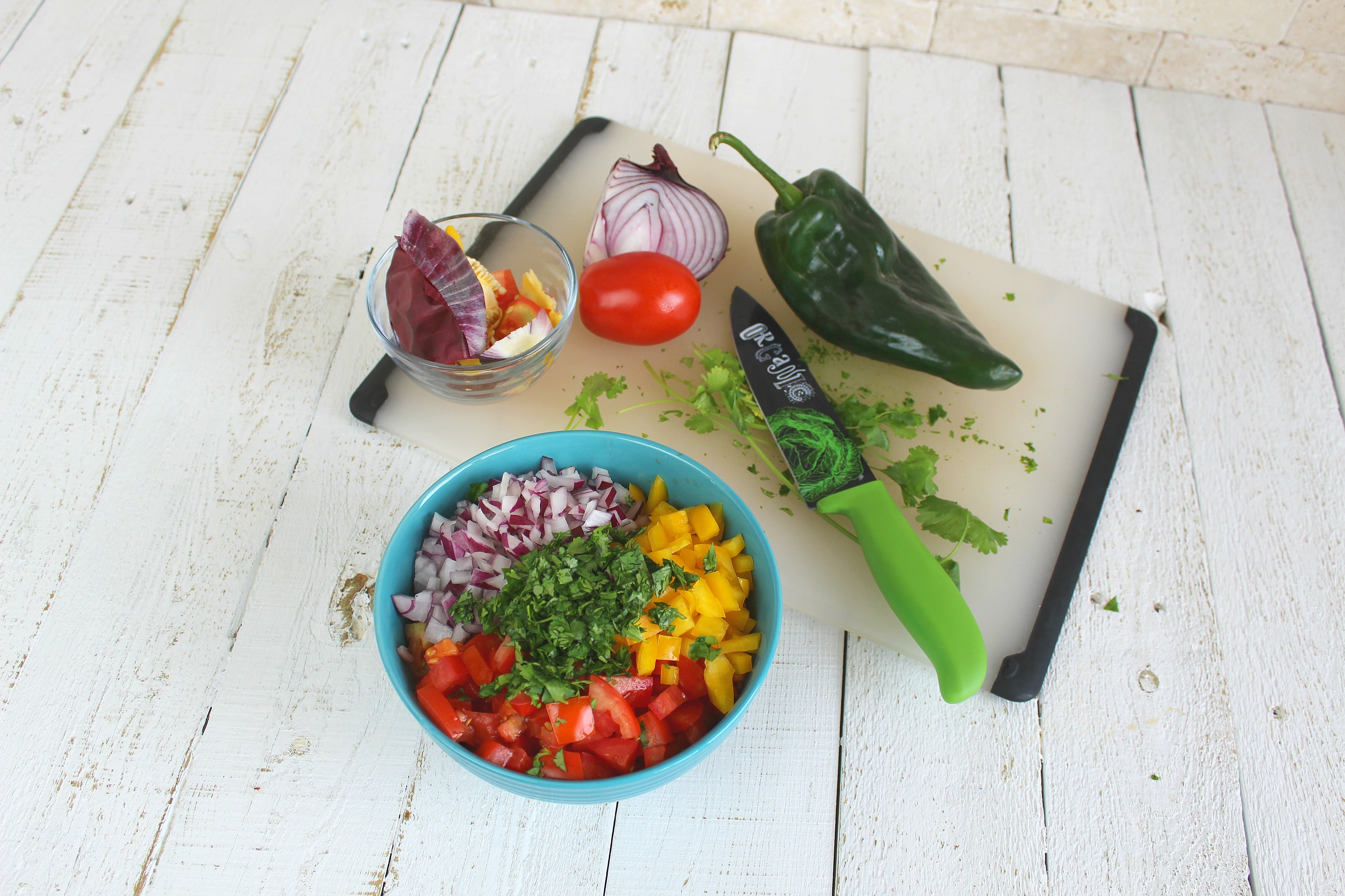 In a medium-sized bowl add tomatoes, yellow pepper, red onion, cilantro, lime juice, olive oil, red wine vinegar and salt.