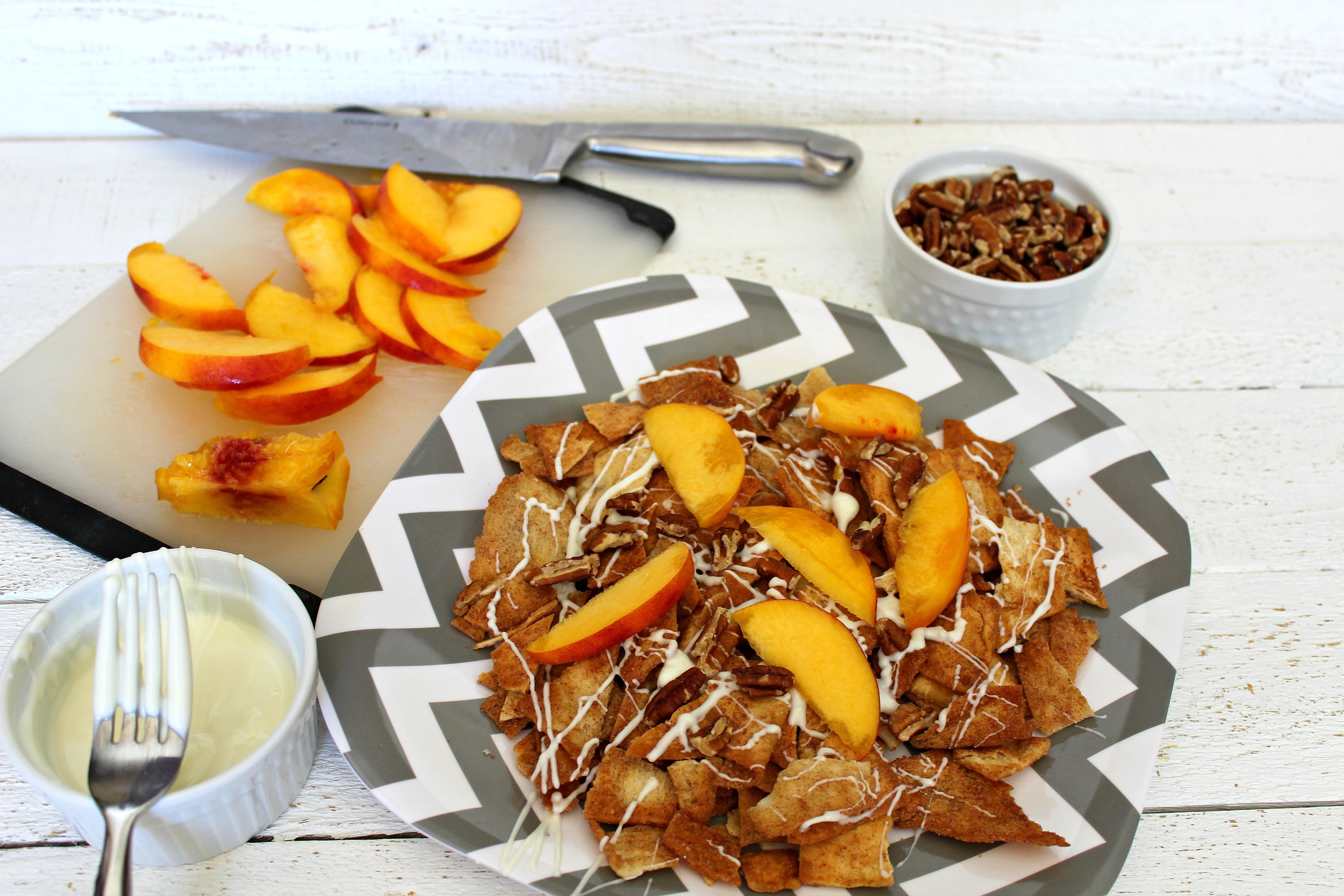 Top cinnamon pita chips with peaches and chopped pecans.