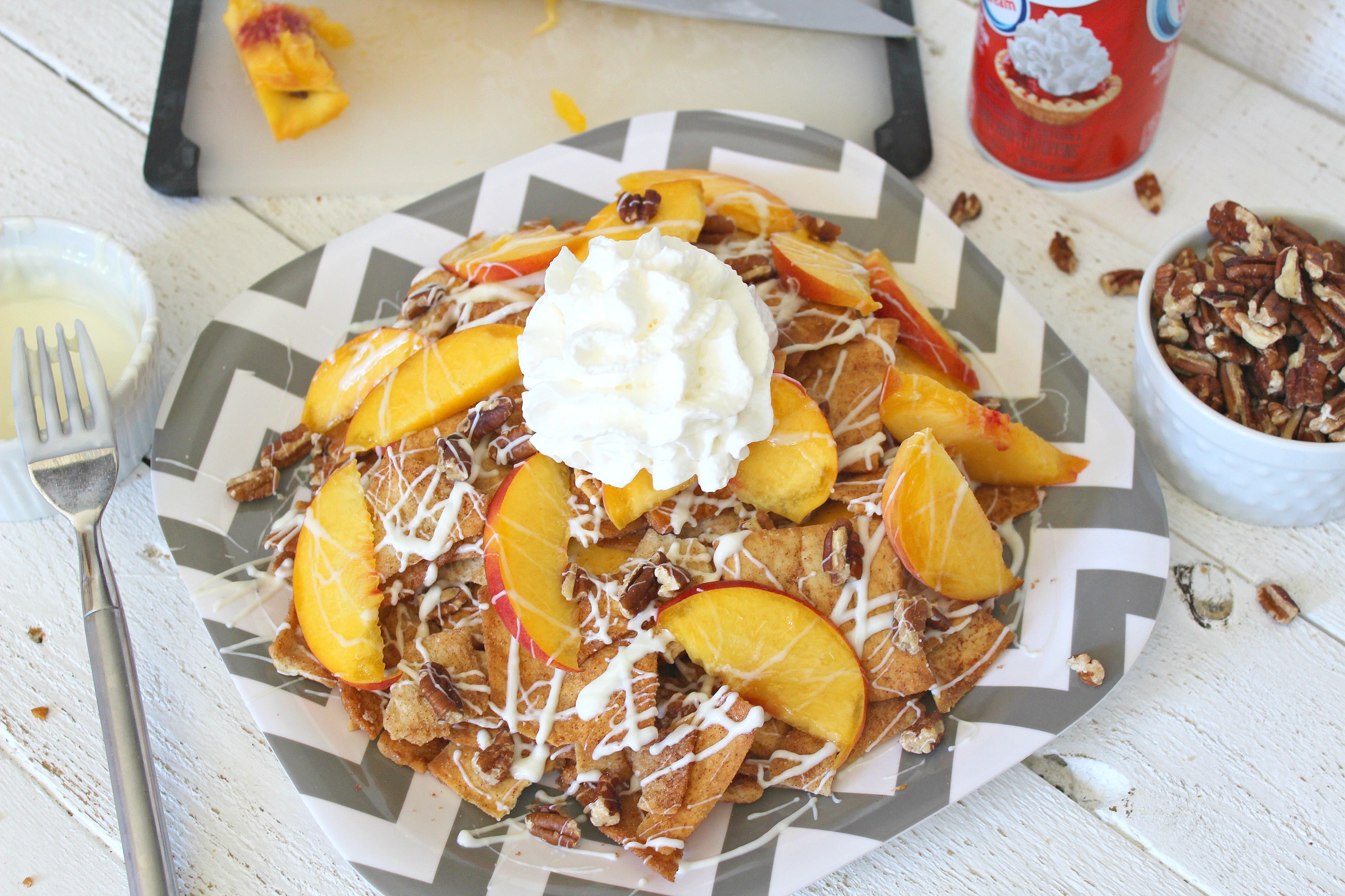 Top of the dessert nachos with whipped cream.