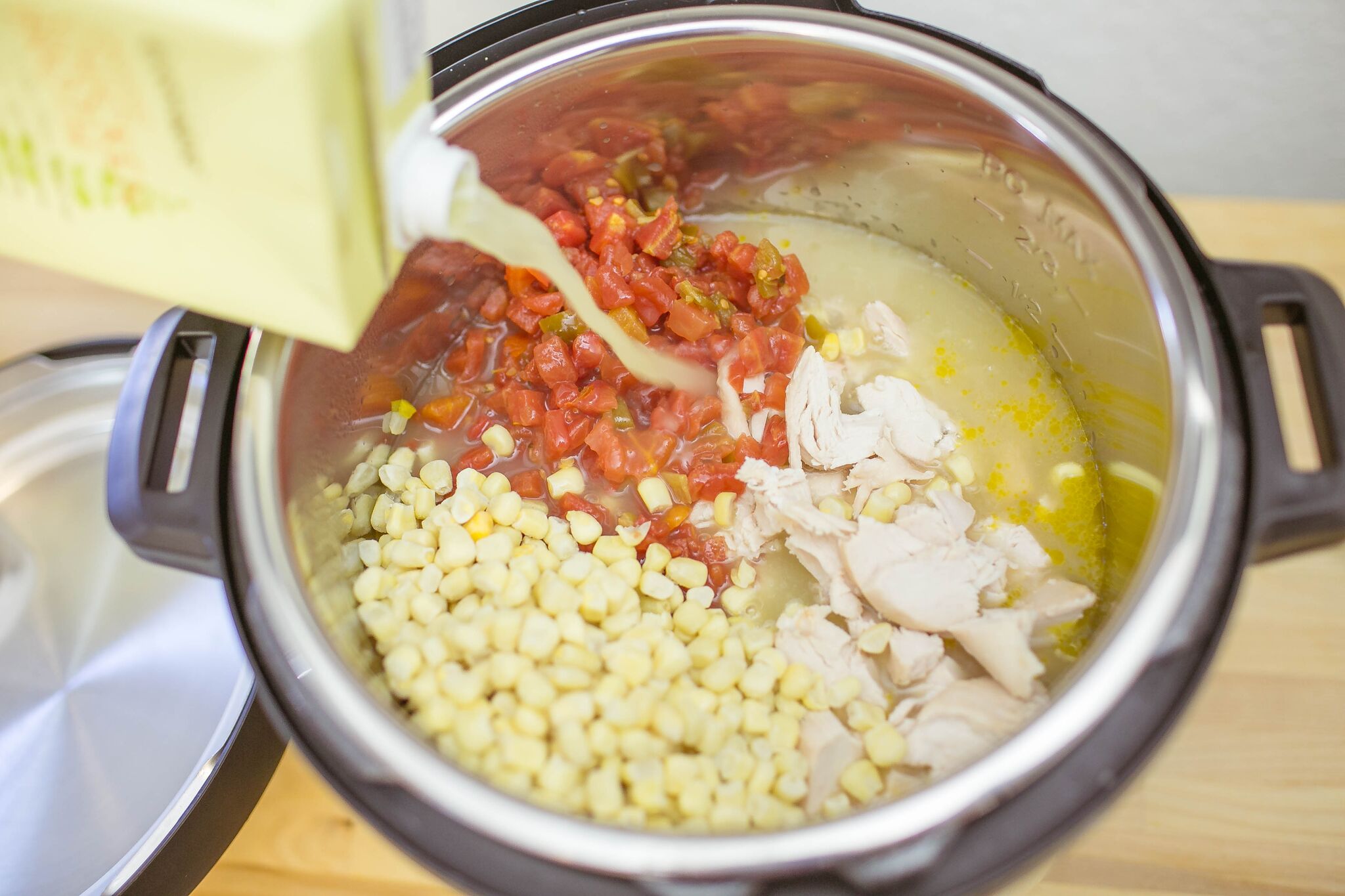 Add shredded chicken, peppers and chicken broth into the instant pot