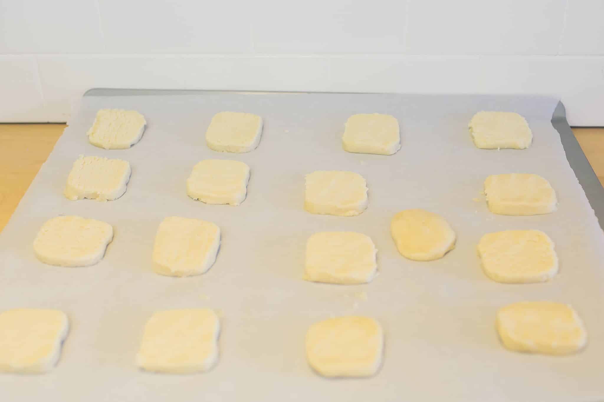 Cut cookie dough into 1/2 slices and place on baking sheet lined with parchment paper.