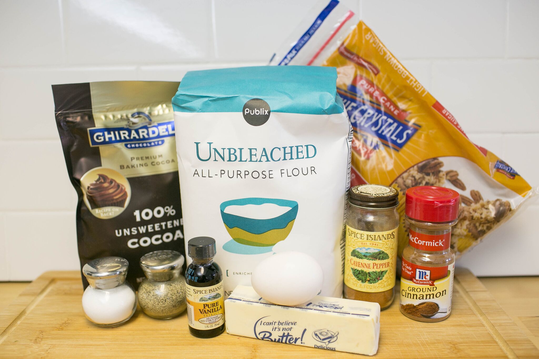 Assemble your ingredients for the spicy chocolate cookies: flour, cocoa powder, cinnamon, salt, pepper, cayenne pepper, butter, brown sugar, egg and vanilla. 