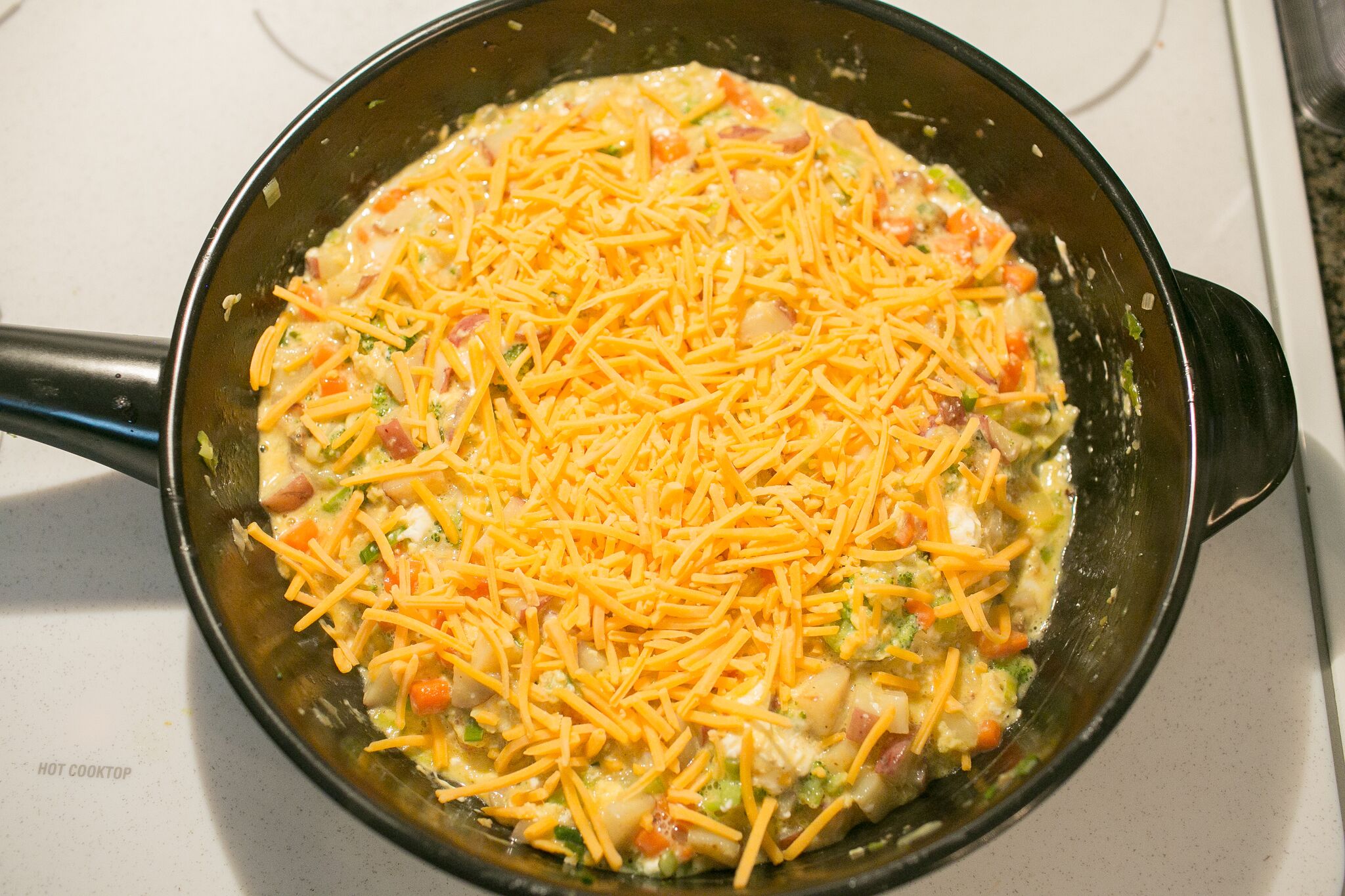 Sprinkle scramble with cheese and let sit until it just begins to melt