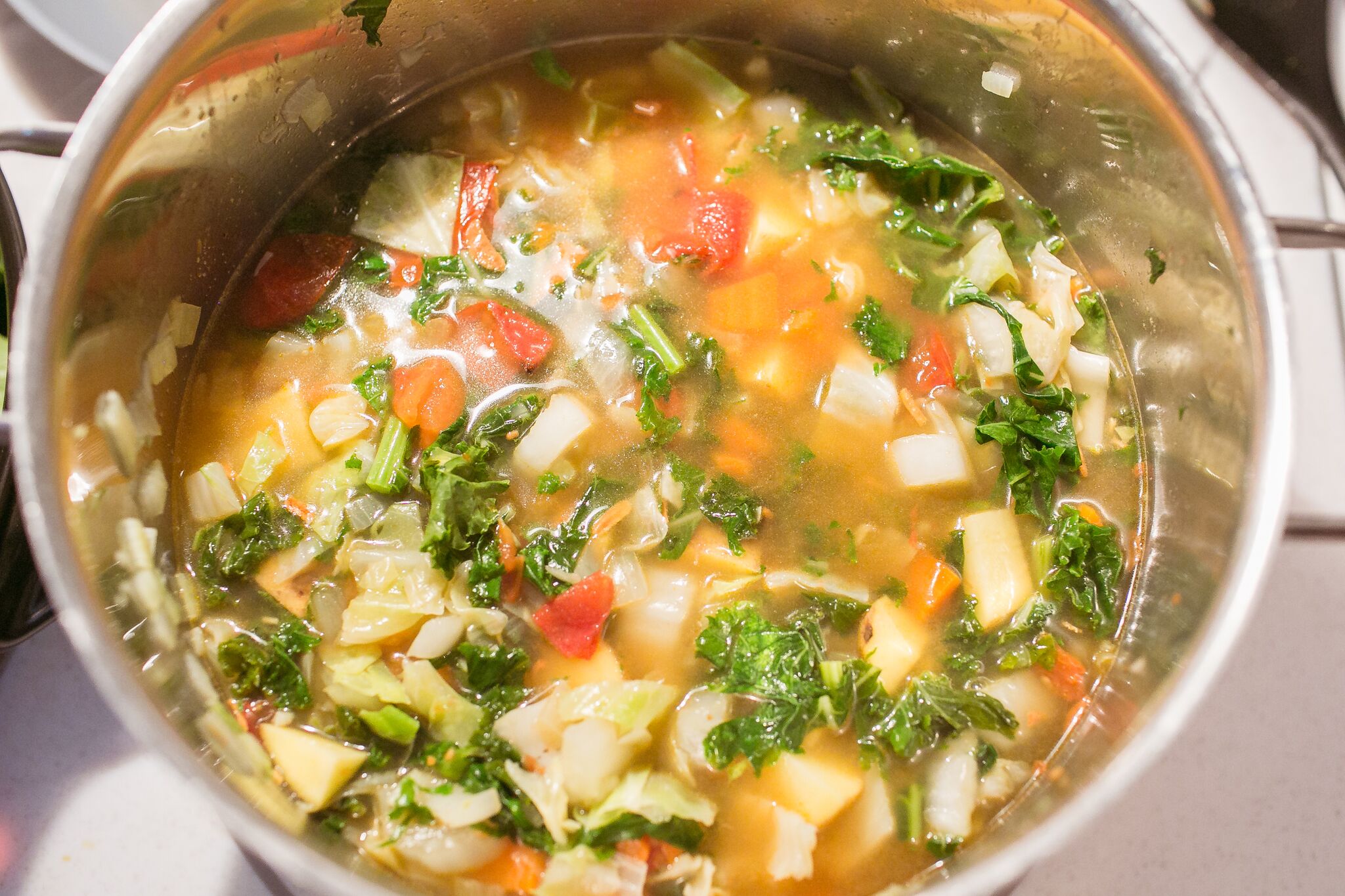 Add in broth and potatoes to soup pot and stir well. 