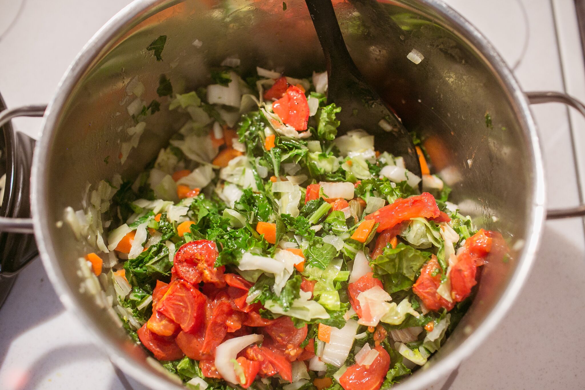 Add all other vegetables to the soup pot and mix ensuring all ingredients are coated with olive oil.