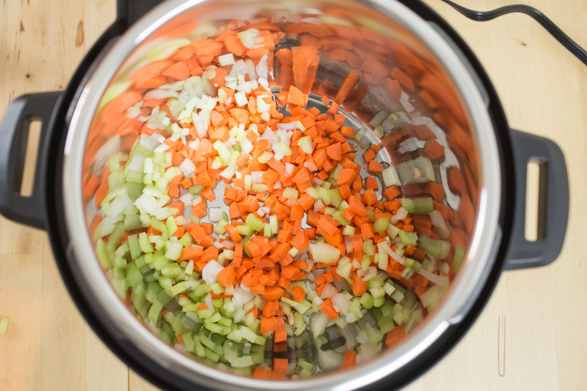 Place olive oil in your Instant pot, set on saute and then add chopped veggies. 