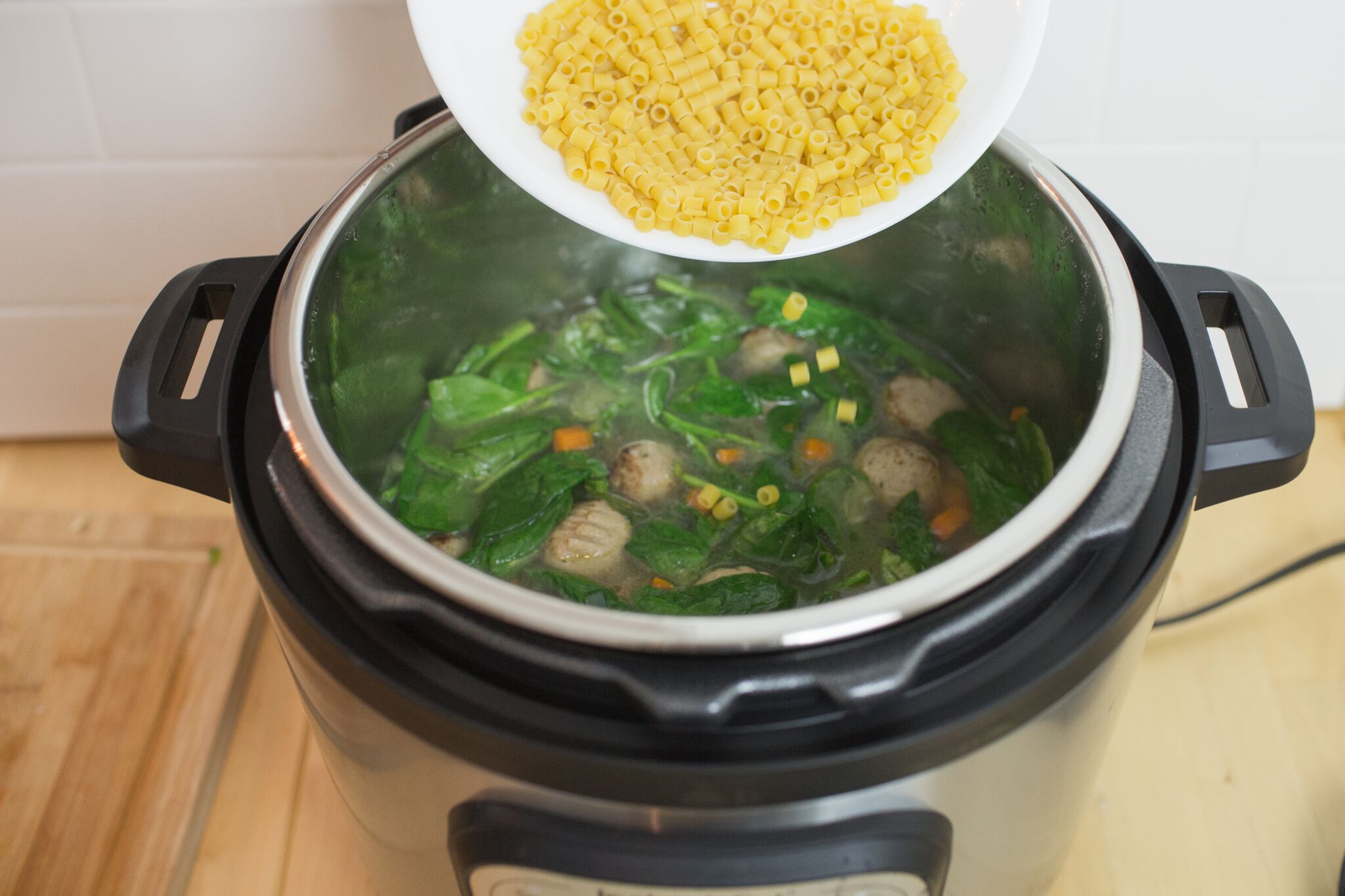 Once the time is ready, remove Instant Pot lid and add in pasta and spinach.