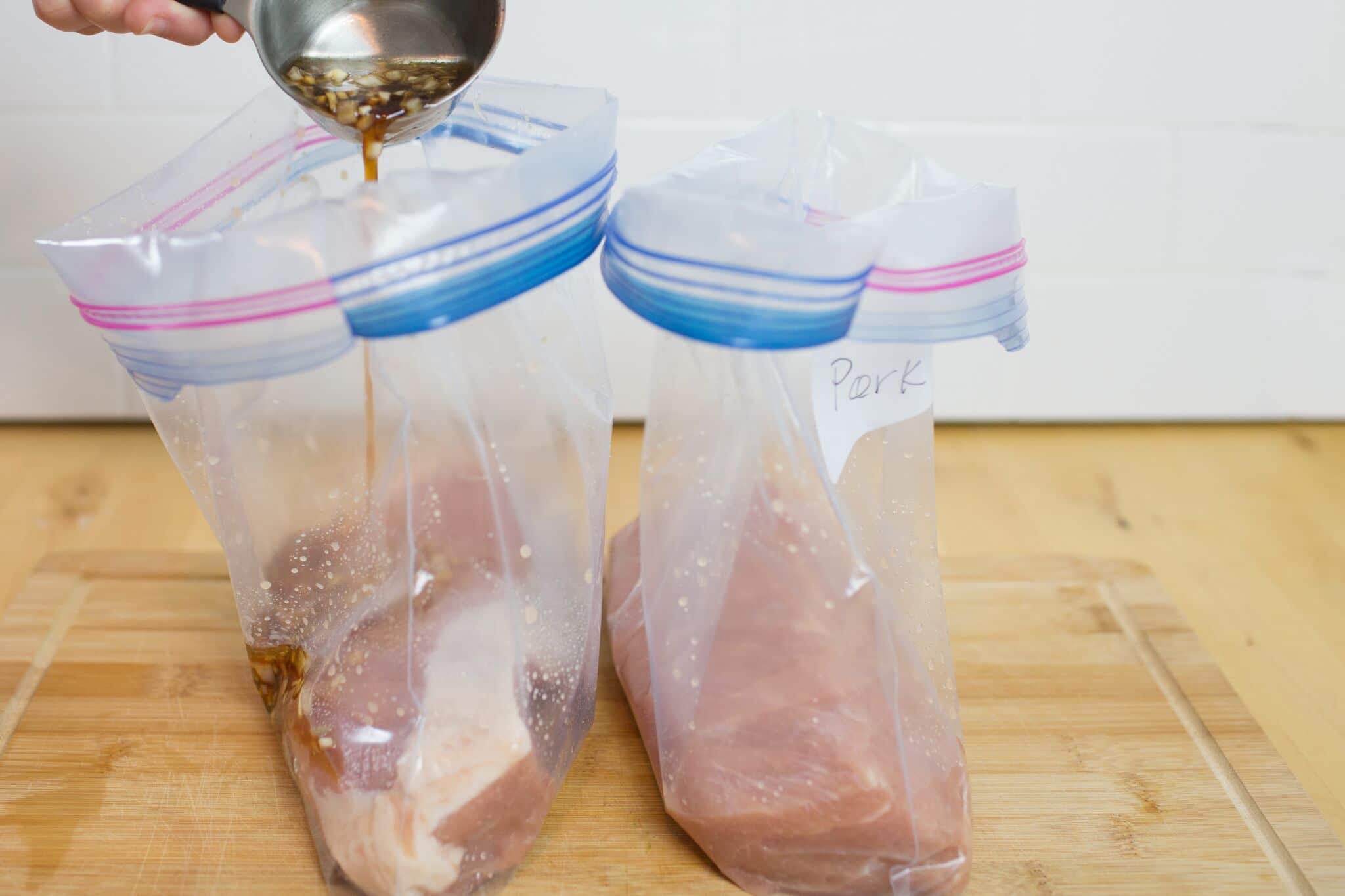 Place pork with marinade into gallon freezer bags. 