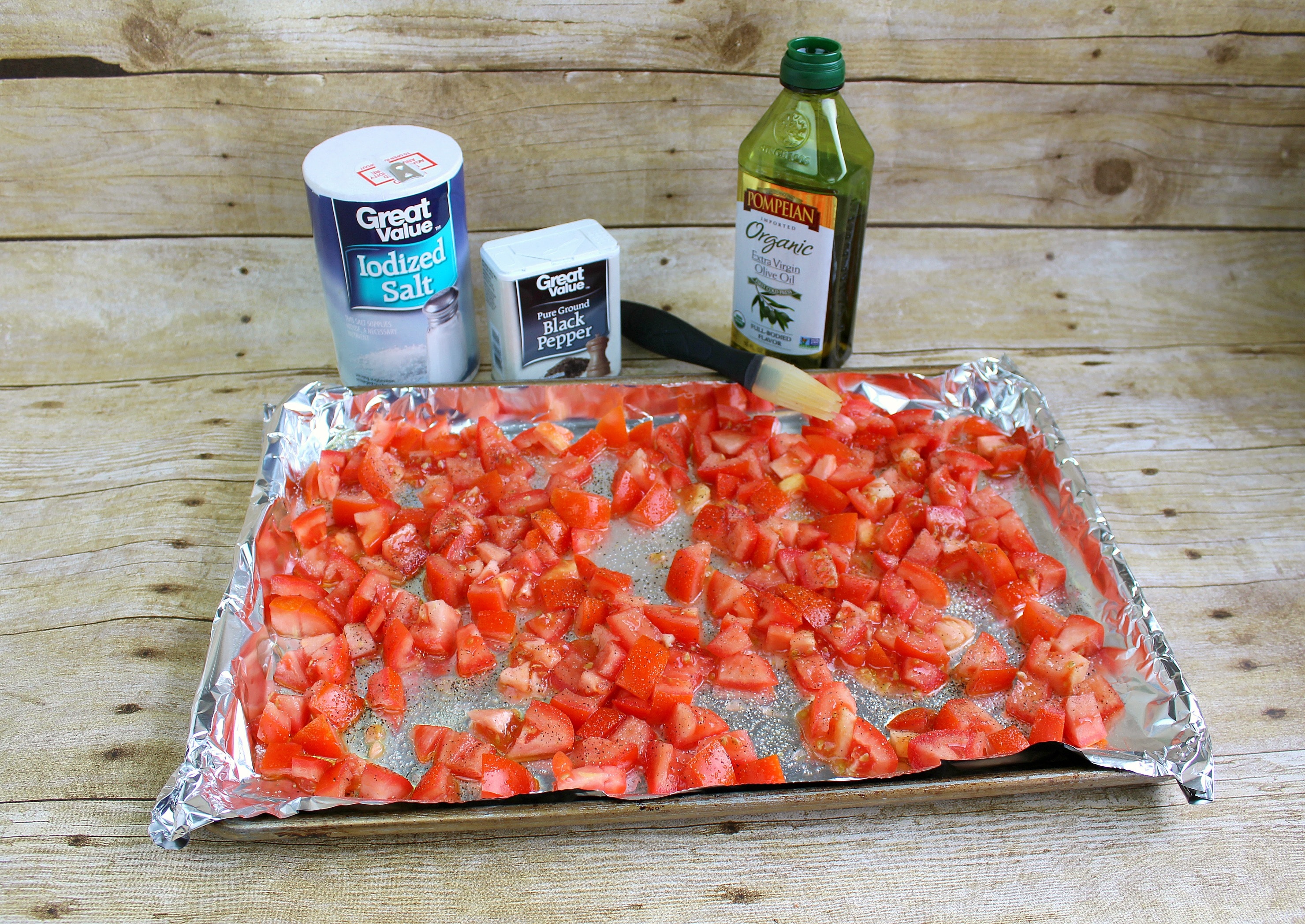 Assemble chopped tomatoes on cookie sheet with tin foil then brush with olive oil and spices. 