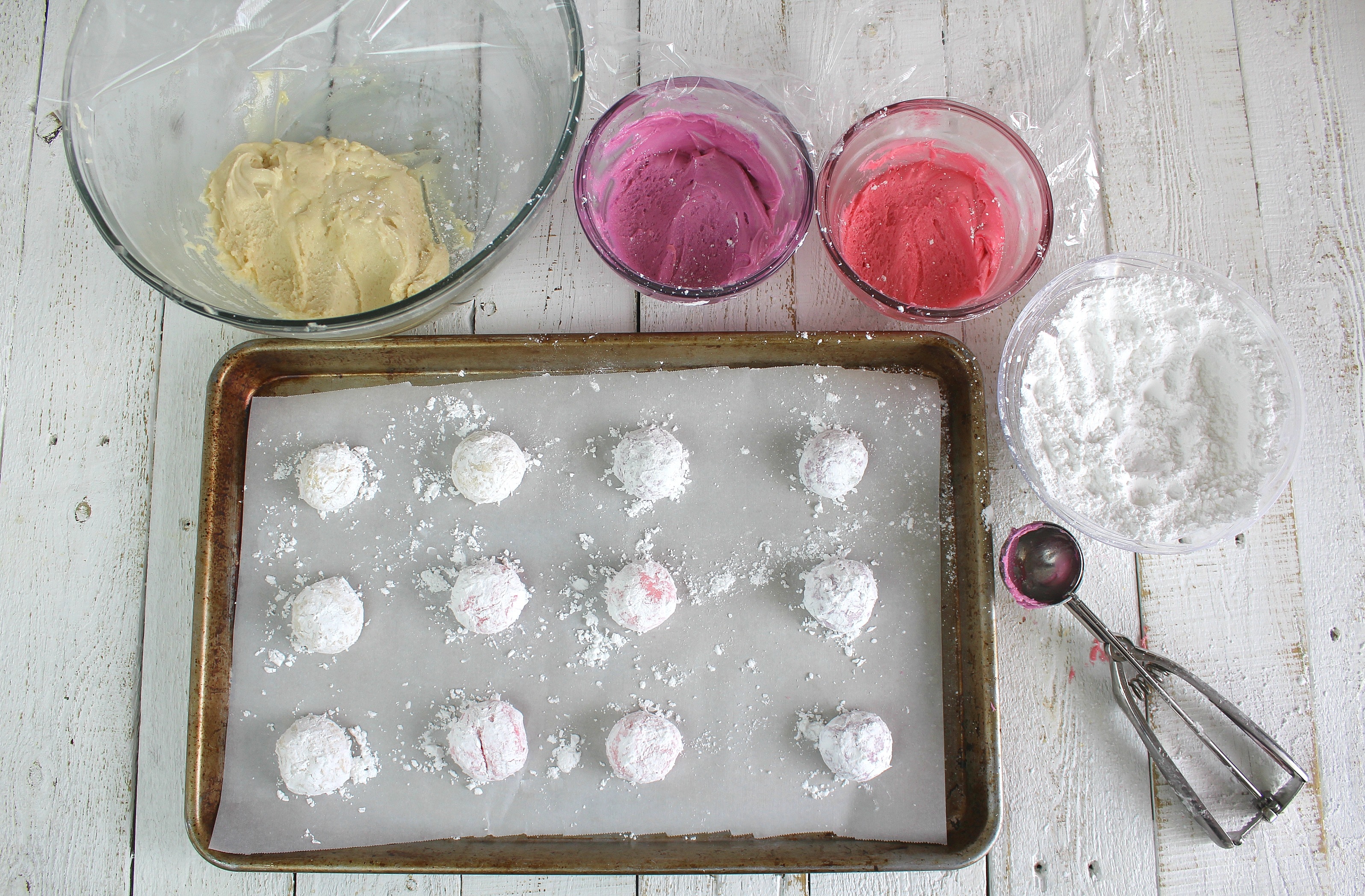 Roll dough into balls and coat in powdered sugar then place on cookie sheet.