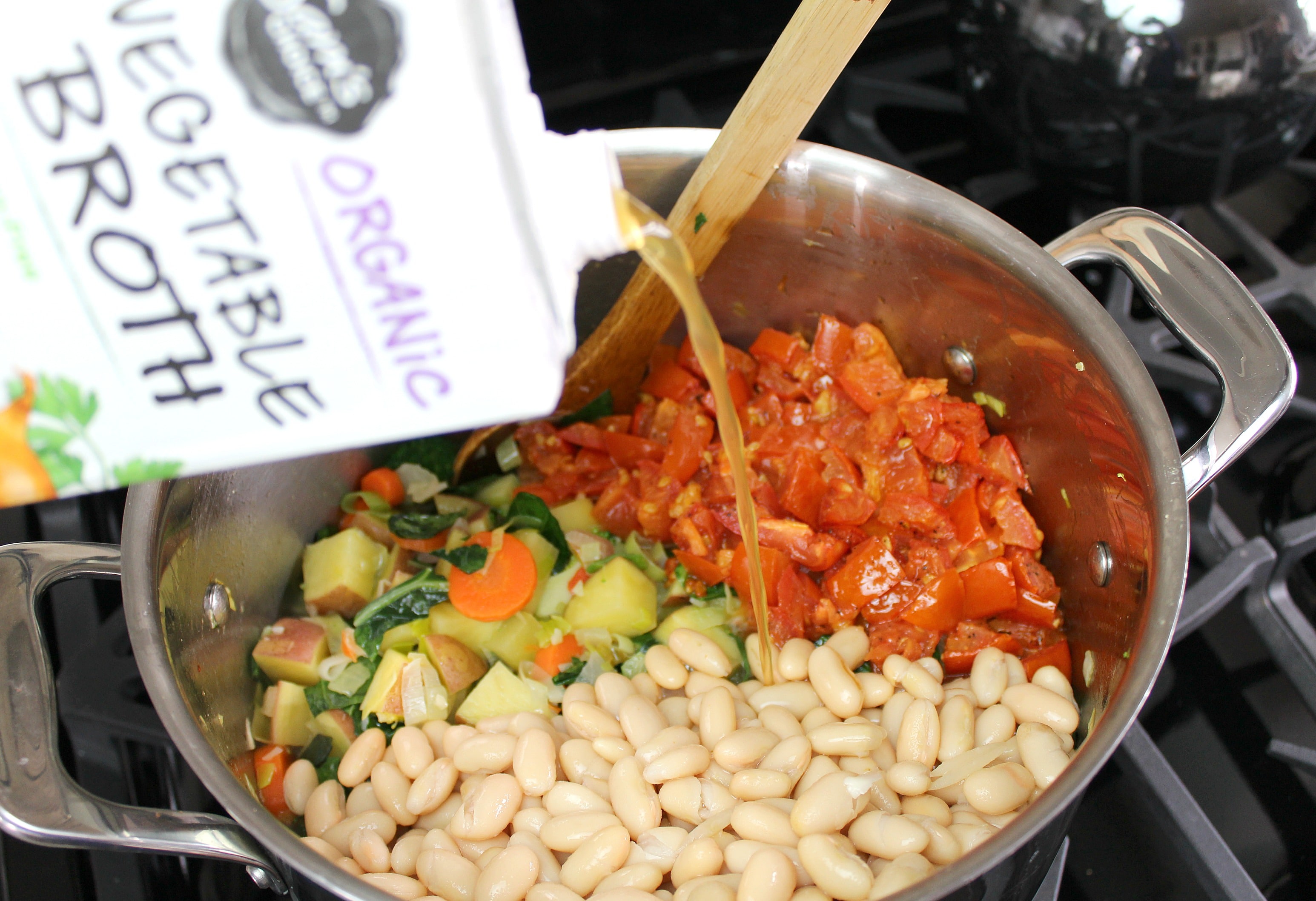 Add kidney beans, broth, and roasted tomatoes to pot of vegetables. 