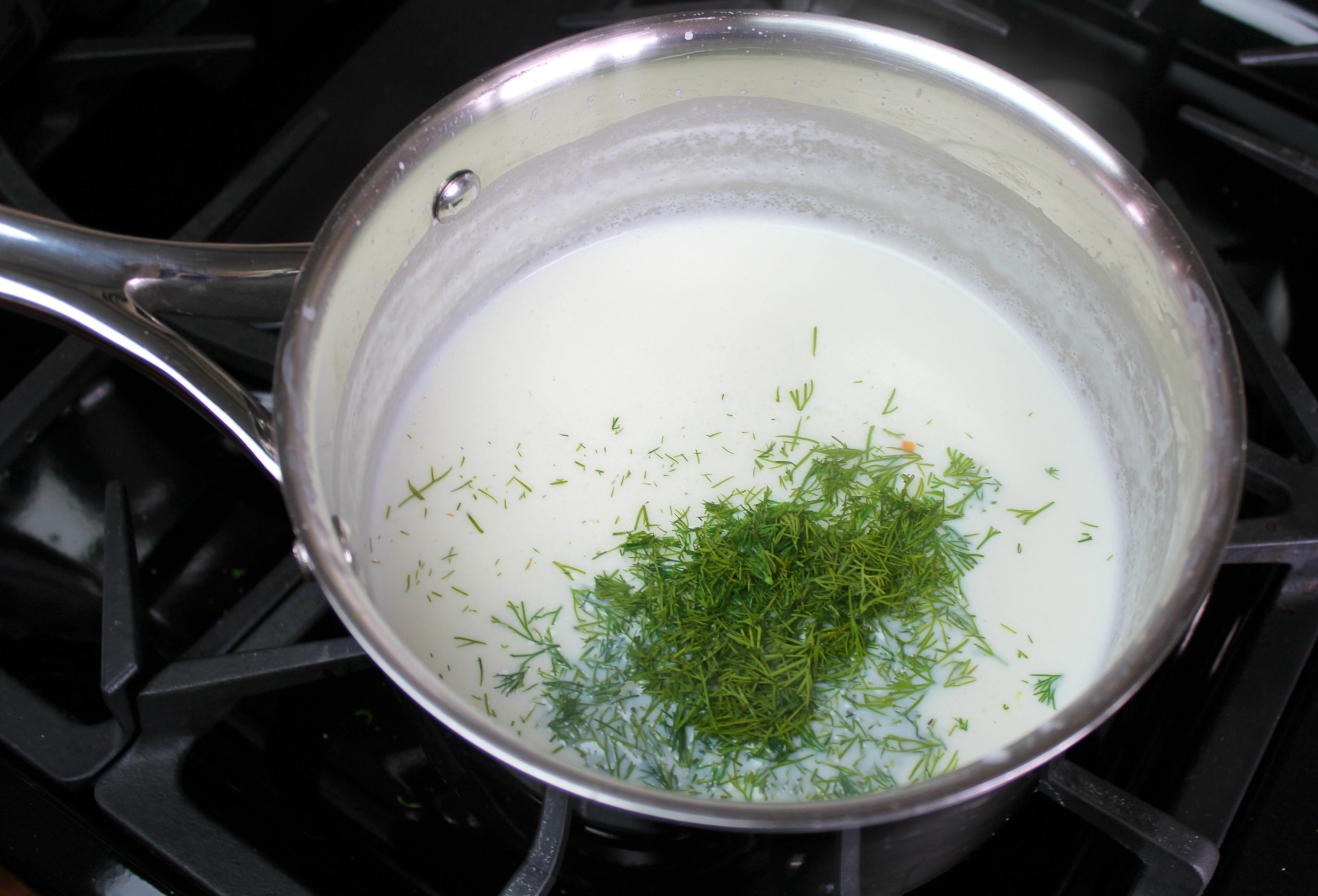 Mix butter, flour, milk, and dill together in a saucepan over medium heat to make a roux. 