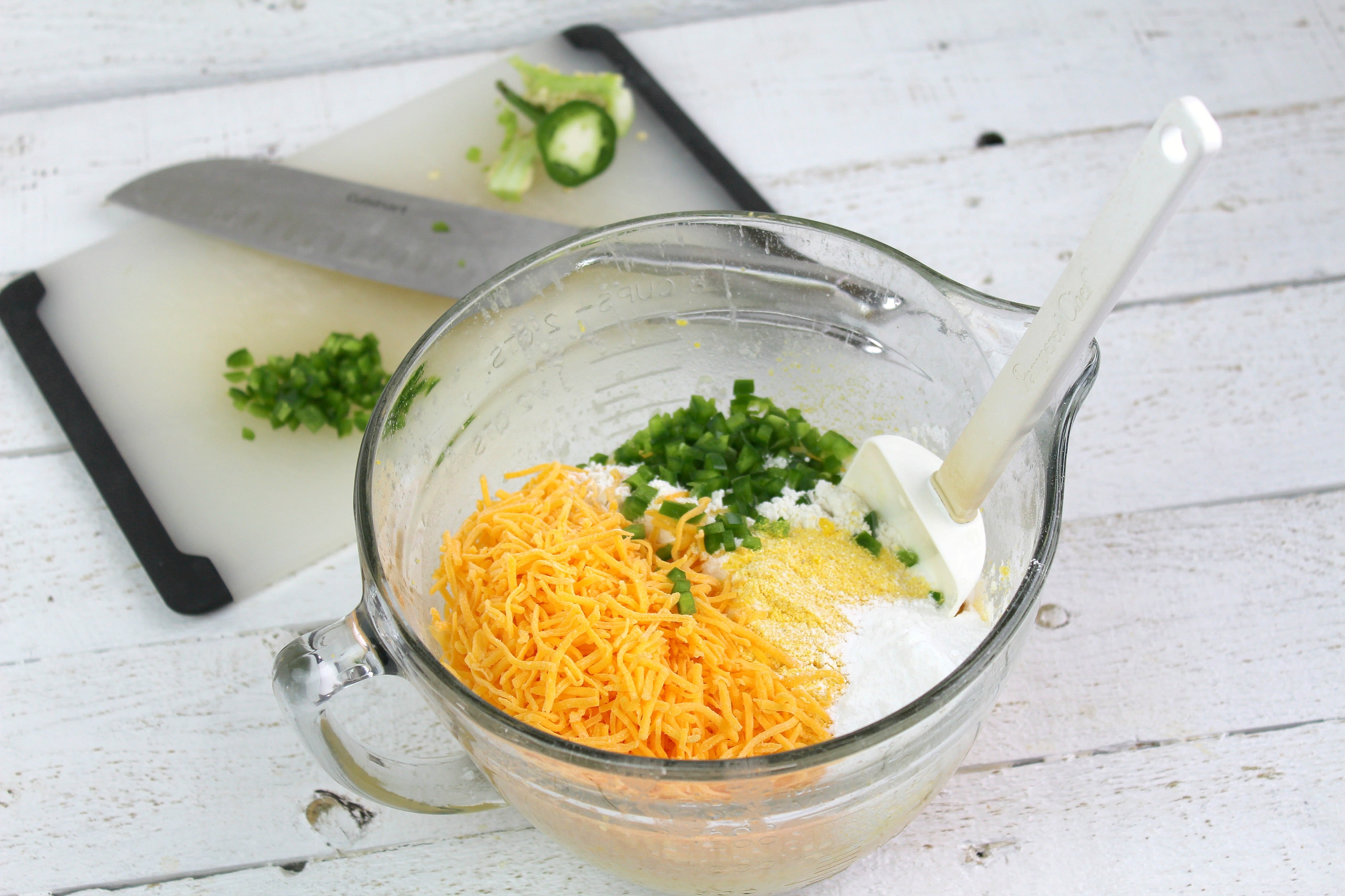 Add shredded cheese and chopped jalapeno to egg mixture