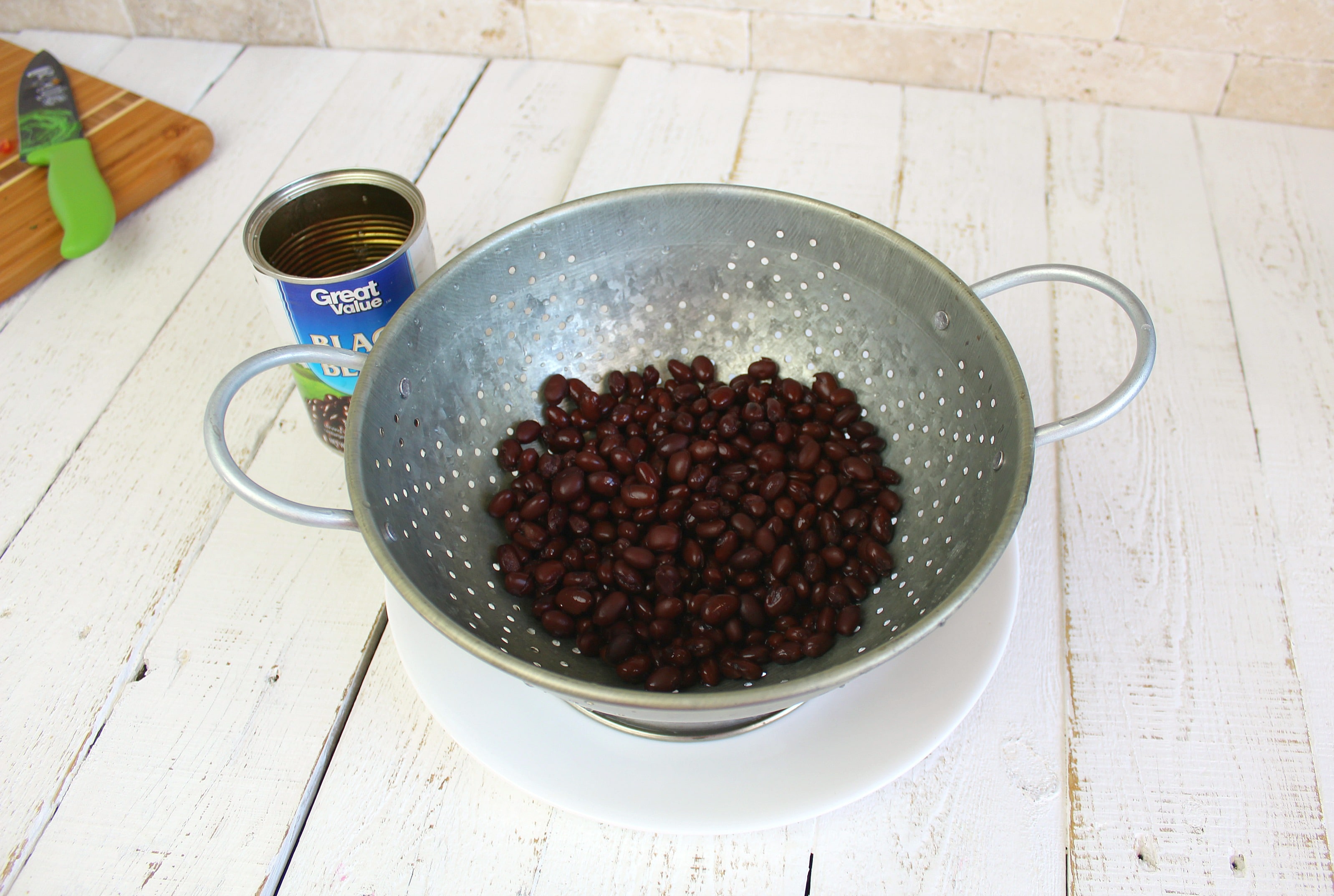 Drain and rinse black beans in colander.