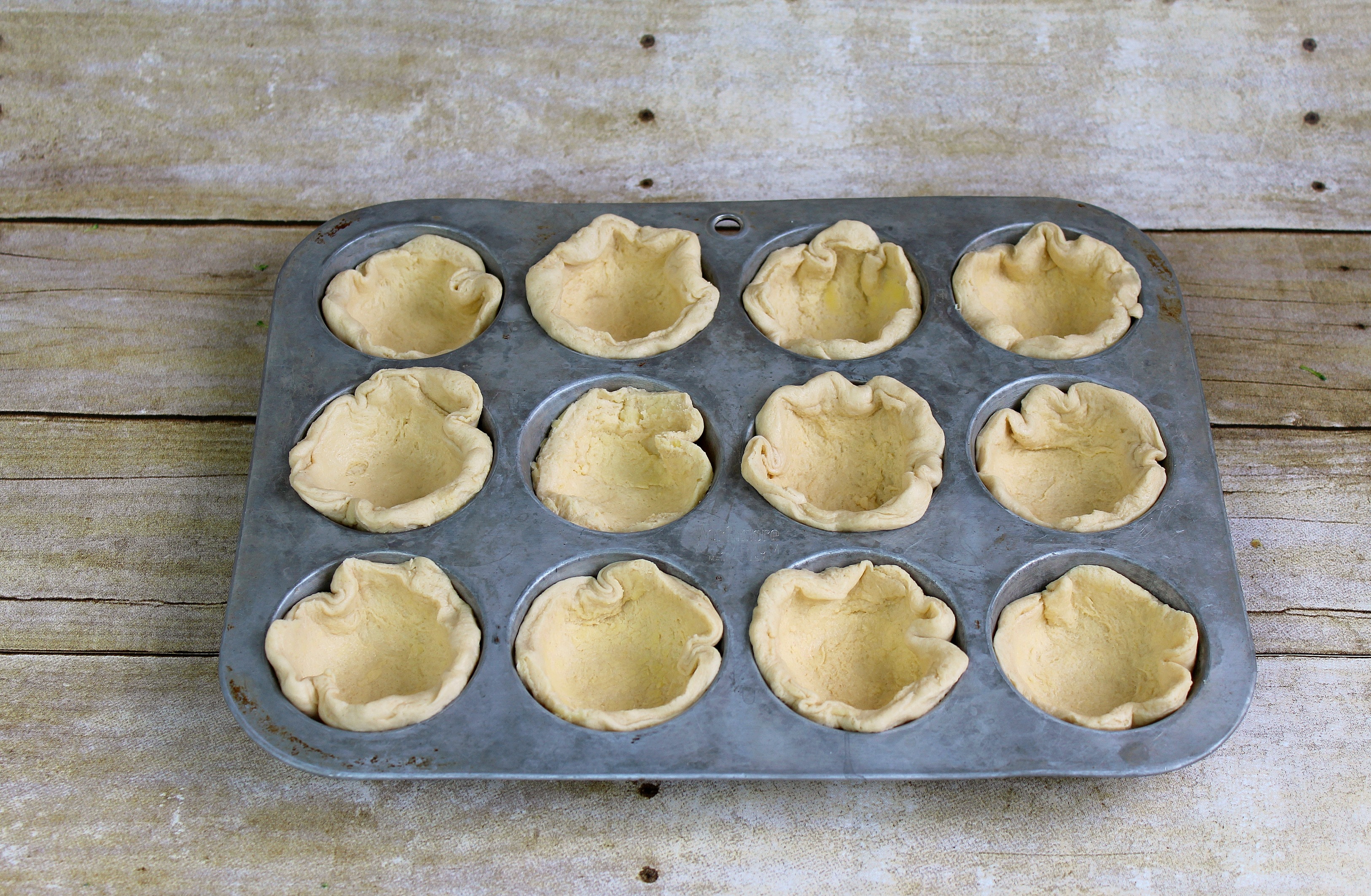Create the cups with biscuit dough in a cupcake pan