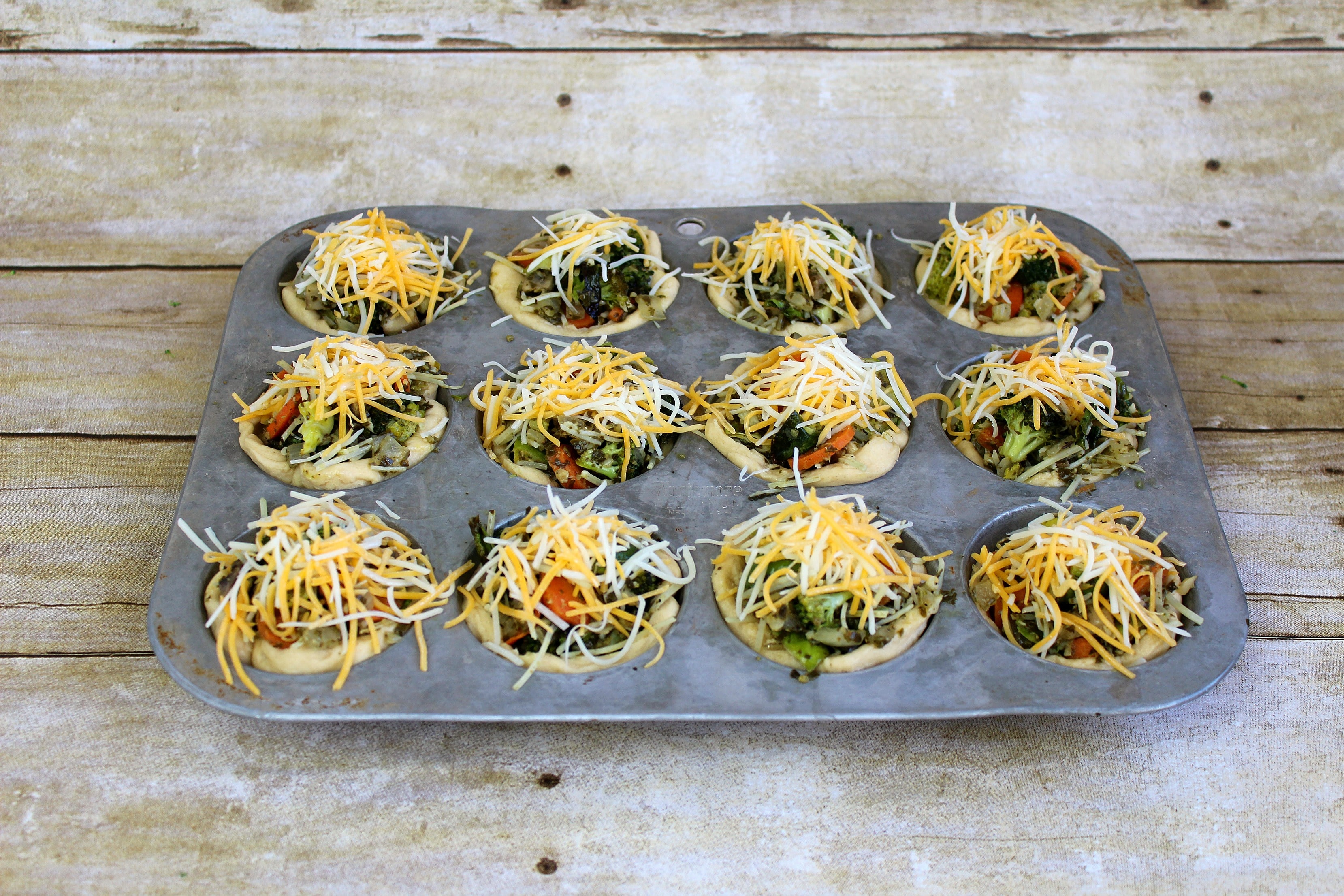 Spoon veggie mixture into biscuit dough cups