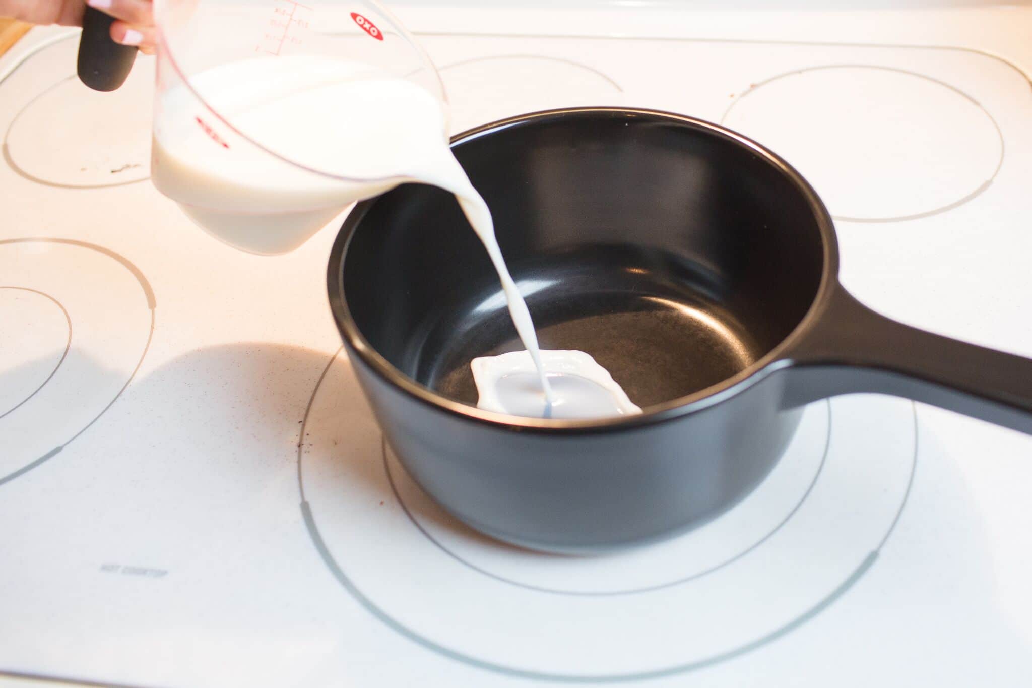 Add milk into a sauce pan over low heat