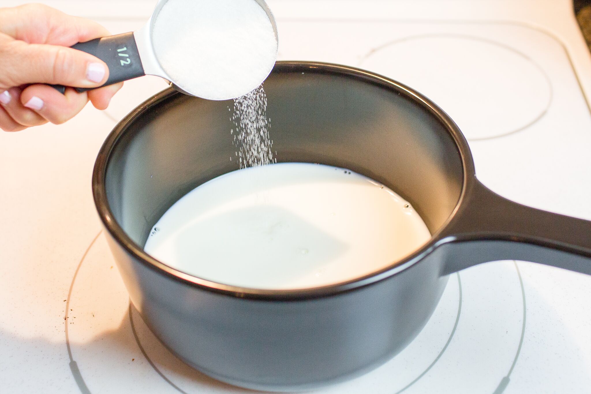 Add sugar to the warm milk