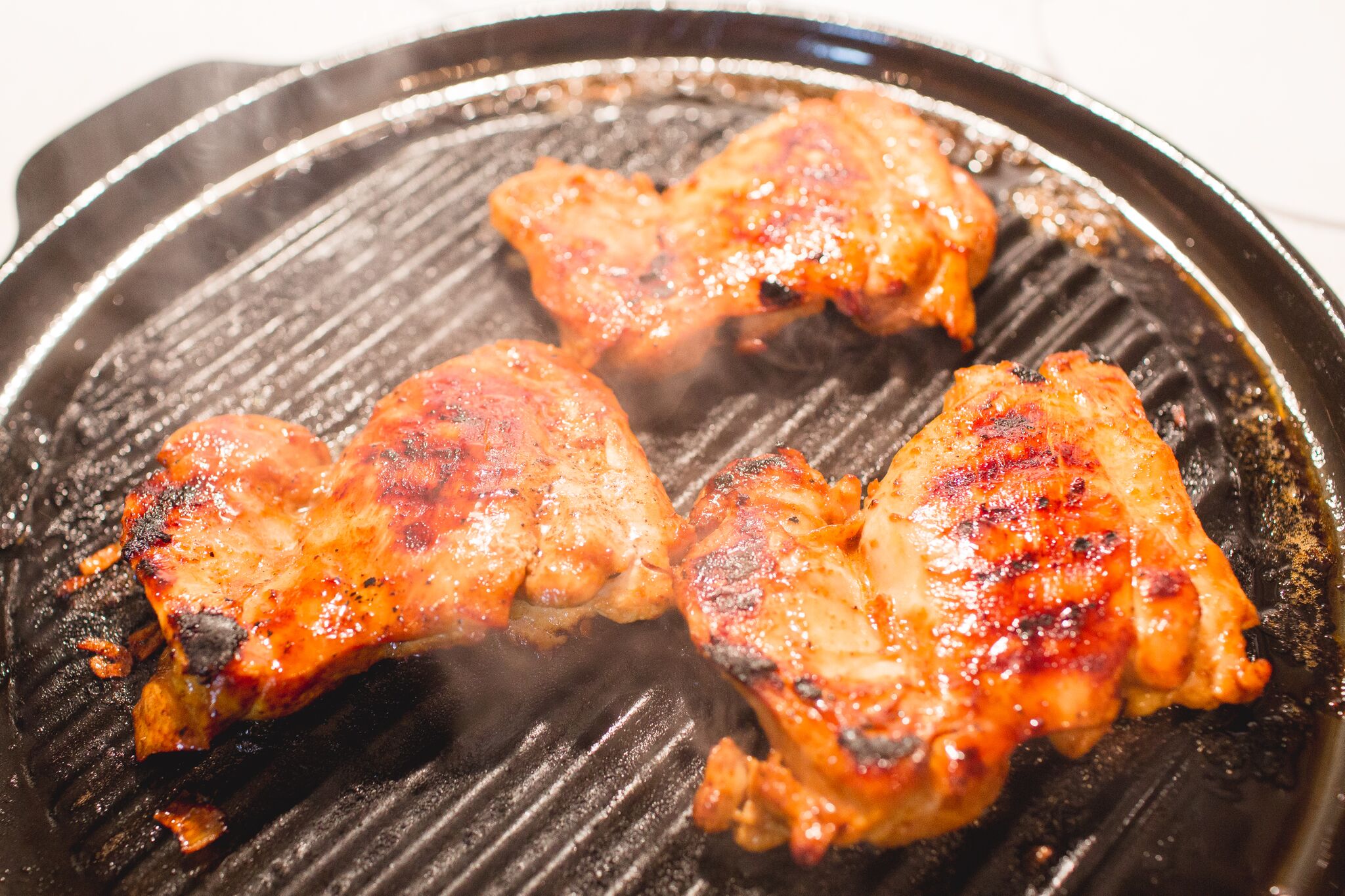 Grill chicken while basting with additional marinade.
