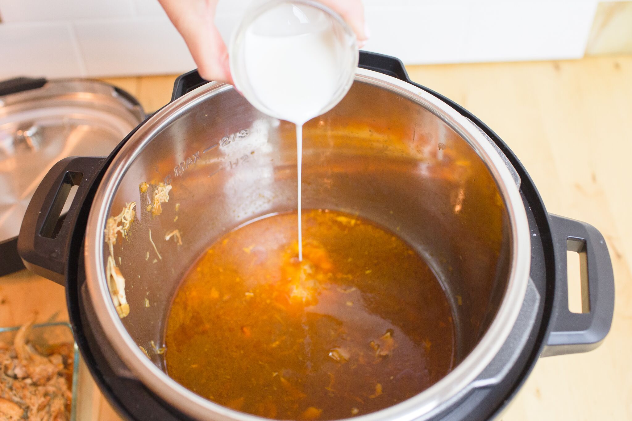 Remove cooked chicken from Instant Pot and a slurry of water and corn starch to the marinade. 