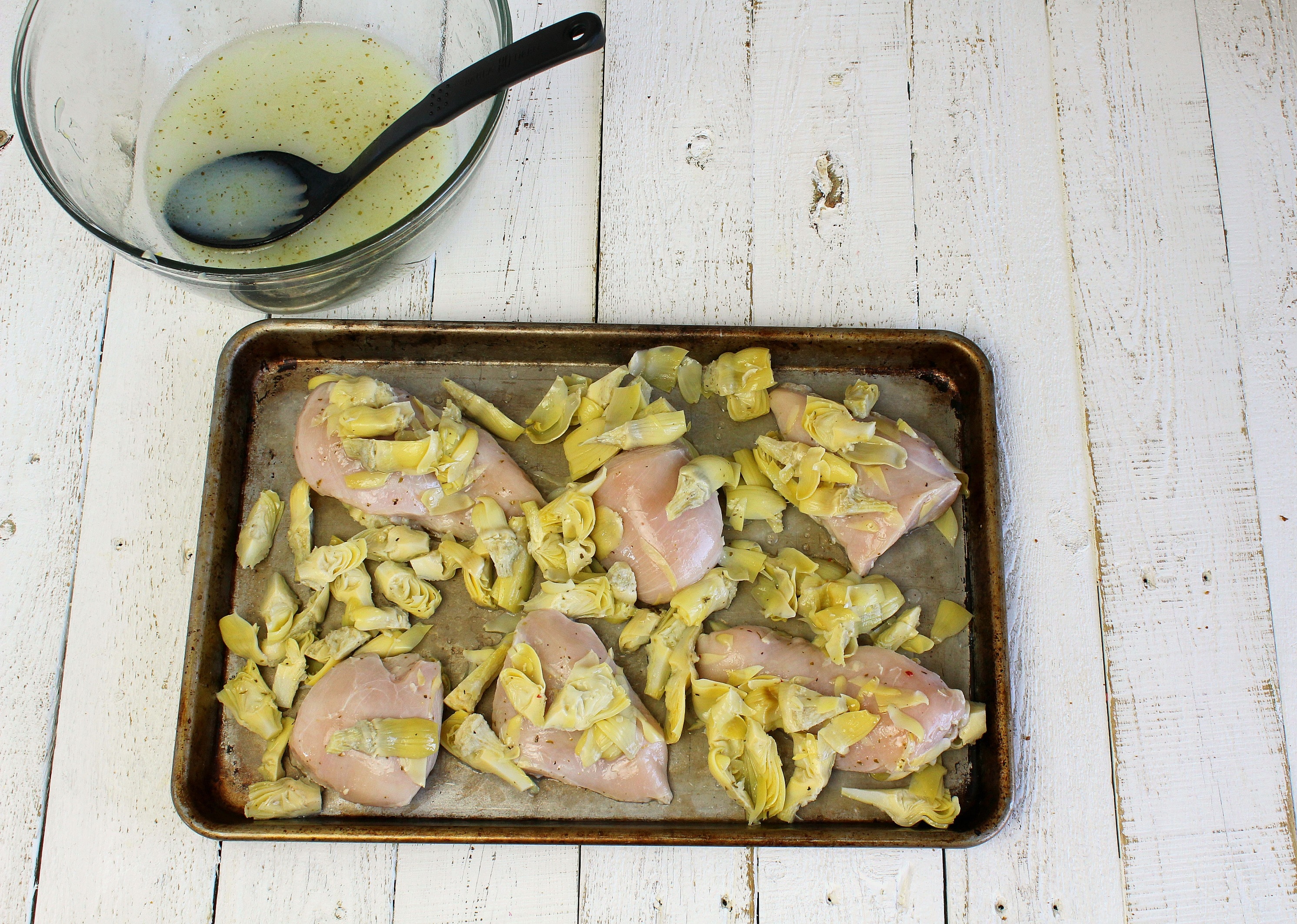 Place marinated chicken on the baking sheet spread out evenly