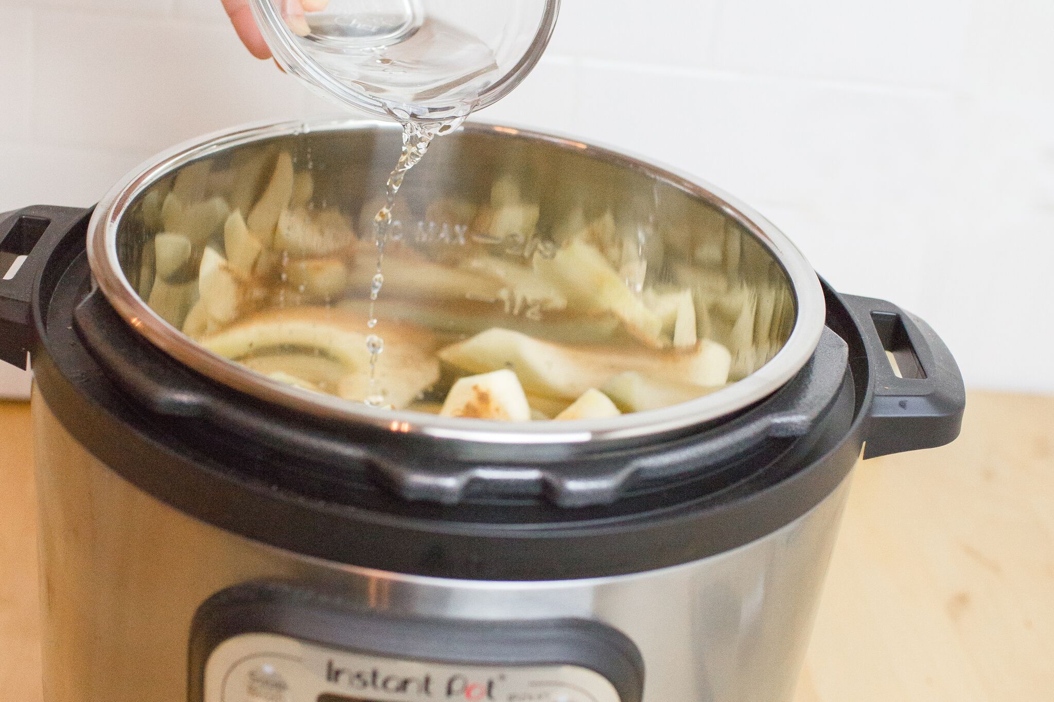 Add cinnamon and water to your apples in the Instant Pot. 
