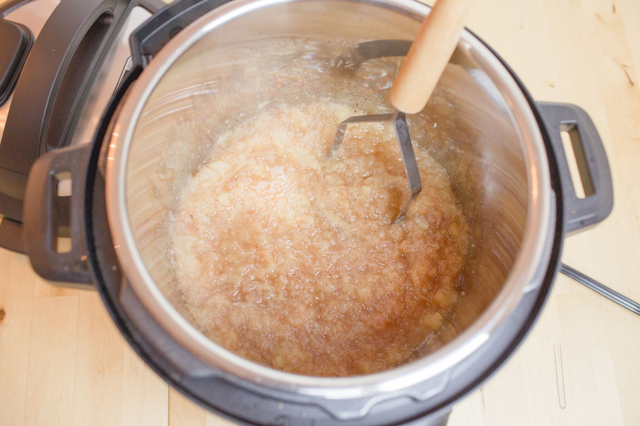 Mash soft apples with a potato masher. 