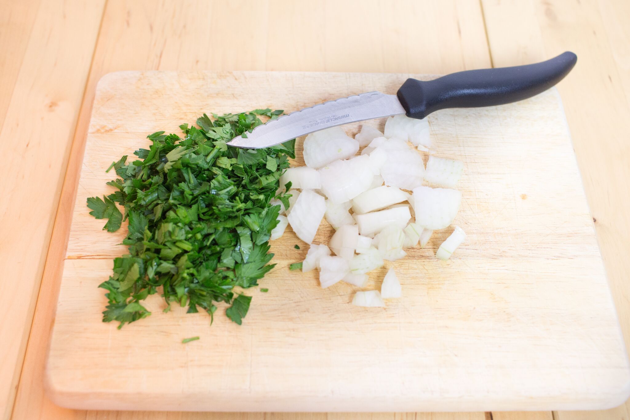 Chop your onion and parsley- Looking for a hearty meal that the whole family will love? This Lasagna Soup recipe tastes great, uses simple, easy-to-find ingredients, and can be made in an hour or less! Did we mention it's a perfect recipe for the Instant Pot too? 