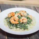 Looking for a keto-friendly recipe, but sick of the same old bunless burgers and breakfast for dinner options? This simple pan-seared shrimp with cheesy spinach and cauliflower rice recipe is high fat, low carb, and 100% delicious!