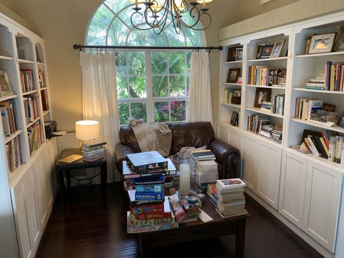 The before picture of the library. Ever feel like your mess has gotten to the point of no return? It might be time to get some help with all that decluttering! Don't miss these three surprising lessons from hiring a professional organizer. Decluttering | Organizing | Hiring a Professional Organizer | Marie Kondo