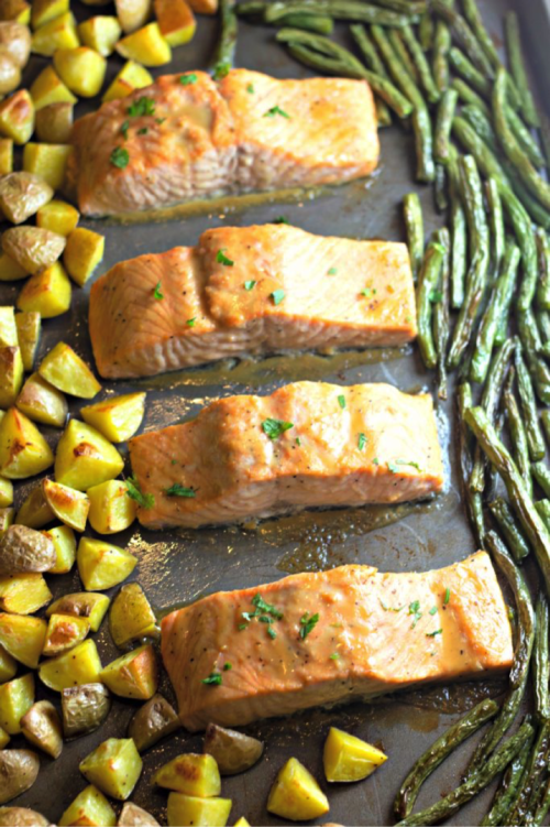 Finish slamon off in pan and then get ready to enjoy your one pot meal. Looking for a quick dinner recipe that uses just 5 ingredients? This Maple Glazed Sheet Pan Salmon with Potatoes and Green Beans is so easy and delicious! #recipes #easyrecipes #seafoodrecipes #onepanrecipes #5ingredientrecipes