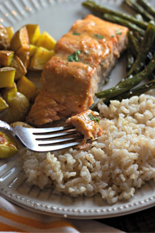 Serve with brown rice if you life. Such a great light meal for any night of the week. Looking for a quick dinner recipe that uses just 5 ingredients? This Maple Glazed Sheet Pan Salmon with Potatoes and Green Beans is so easy and delicious! #recipes #easyrecipes #seafoodrecipes #onepanrecipes #5ingredientrecipes