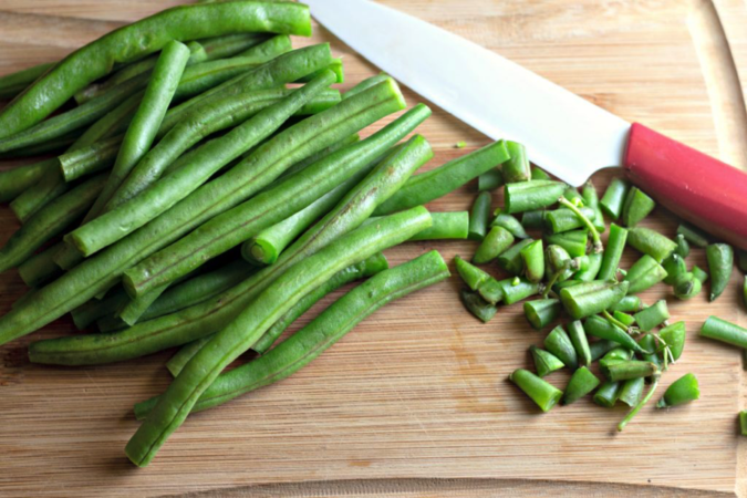 Step one chop green beans. Looking for a quick dinner recipe that uses just 5 ingredients? This Maple Glazed Sheet Pan Salmon with Potatoes and Green Beans is so easy and delicious! #recipes #easyrecipes #seafoodrecipes #onepanrecipes #5ingredientrecipes