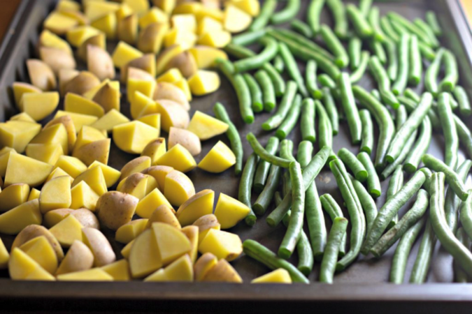 Bake potatoes and green beans together. Looking for a quick dinner recipe that uses just 5 ingredients? This Maple Glazed Sheet Pan Salmon with Potatoes and Green Beans is so easy and delicious! #recipes #easyrecipes #seafoodrecipes #onepanrecipes #5ingredientrecipes