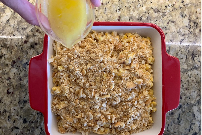Pour melted butter over crushed crackers-It's hard to find a side dish that even the pickiest eaters will embrace, but this Creamy Corn Casserole with crushed Ritz Cracker topping definitely does the trick. It's easy, delicious and always a hit--your new holiday go-to recipe! #recipes #cornrecipes #casserolerecipes #kidfriendlyrecipes #easyrecipes #holidayrecipes
