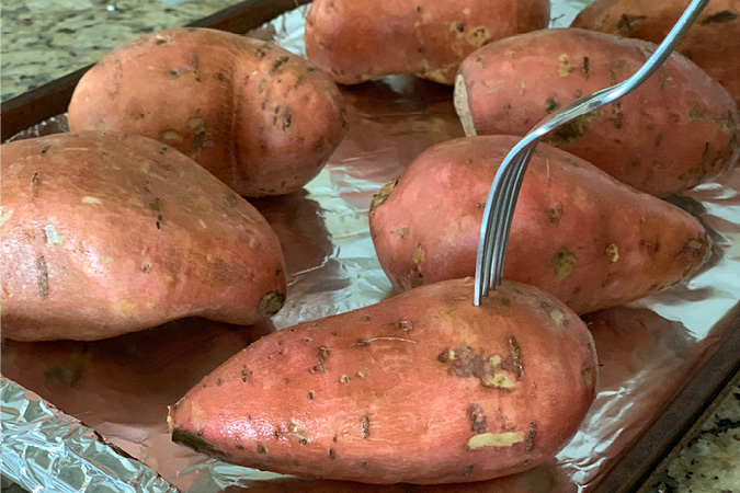 Step 1 fork potatoes before baking-A word of warning--once you've tried these incredible Twice Baked Sweet Potatoes, no other sweet potatoes will ever quite compare! They're not only utterly delicious (not to mention semi-addicting) and also a complete show-stopper for your Thanksgiving dinner. #recipes #thanksgivingrecipes #holidayrecipes #easyrecipes